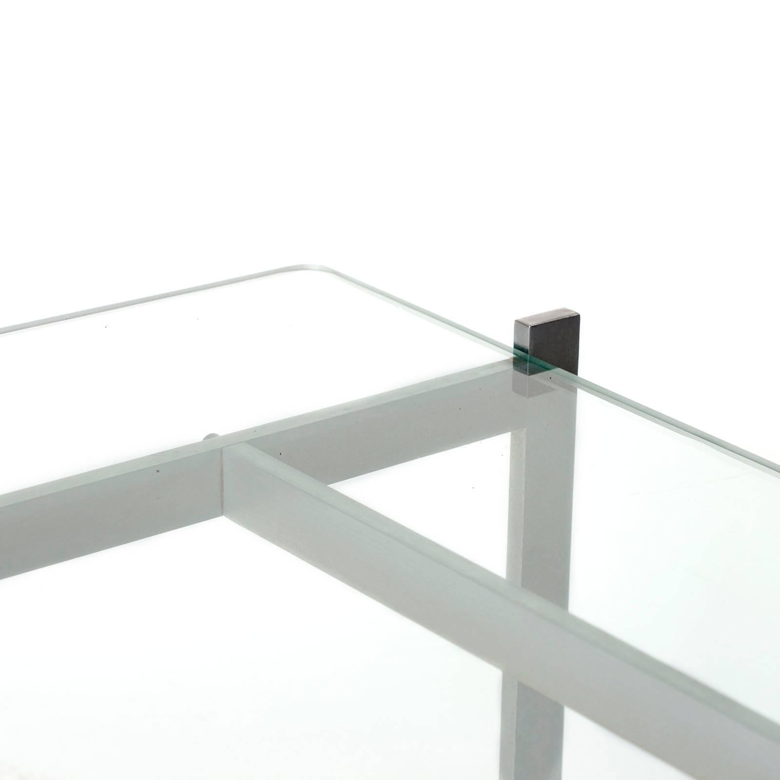 Early coffee table designed by Poul Kjærholm in 1956. Manufactured by E. Kold Christensen, the stamp of the manufactured is present on the structure. Matt chrome-plated steel frame, glass top, with a small chip under on one corner.

Free shipping