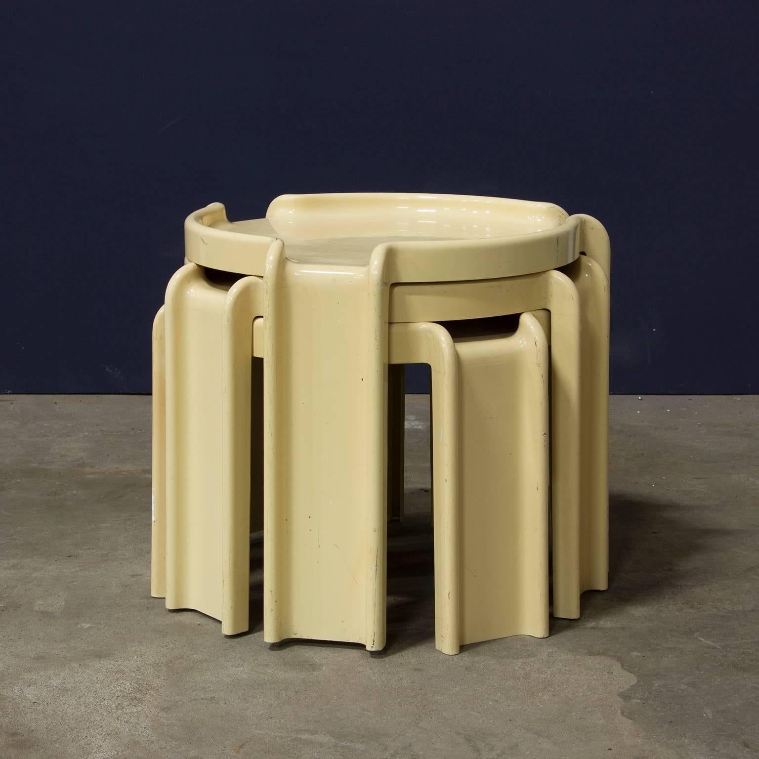 Set of three stackable Kartell side tables in white. 
Some traces of wear and the color changed over the years.

Height of highest table is 41 cm.
Height of middle table 37 cm.
Height of lowest table 33 cm.

The diameter of the table from leg to
