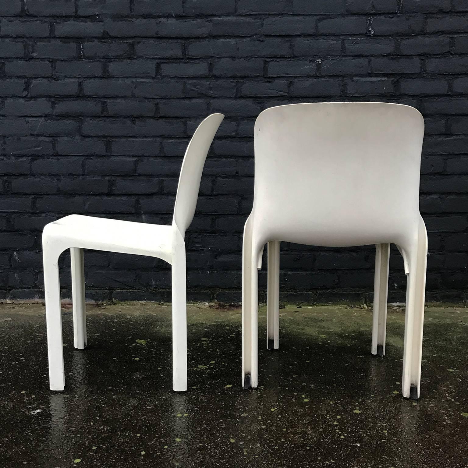 Set of four white Selene stacking chairs. The chairs have traces of wear like some stains, scratches and it seems like a bit smudgy on the backrests of some of the chairs etc. The appearance of the chairs is dull and not shiny but that might be the