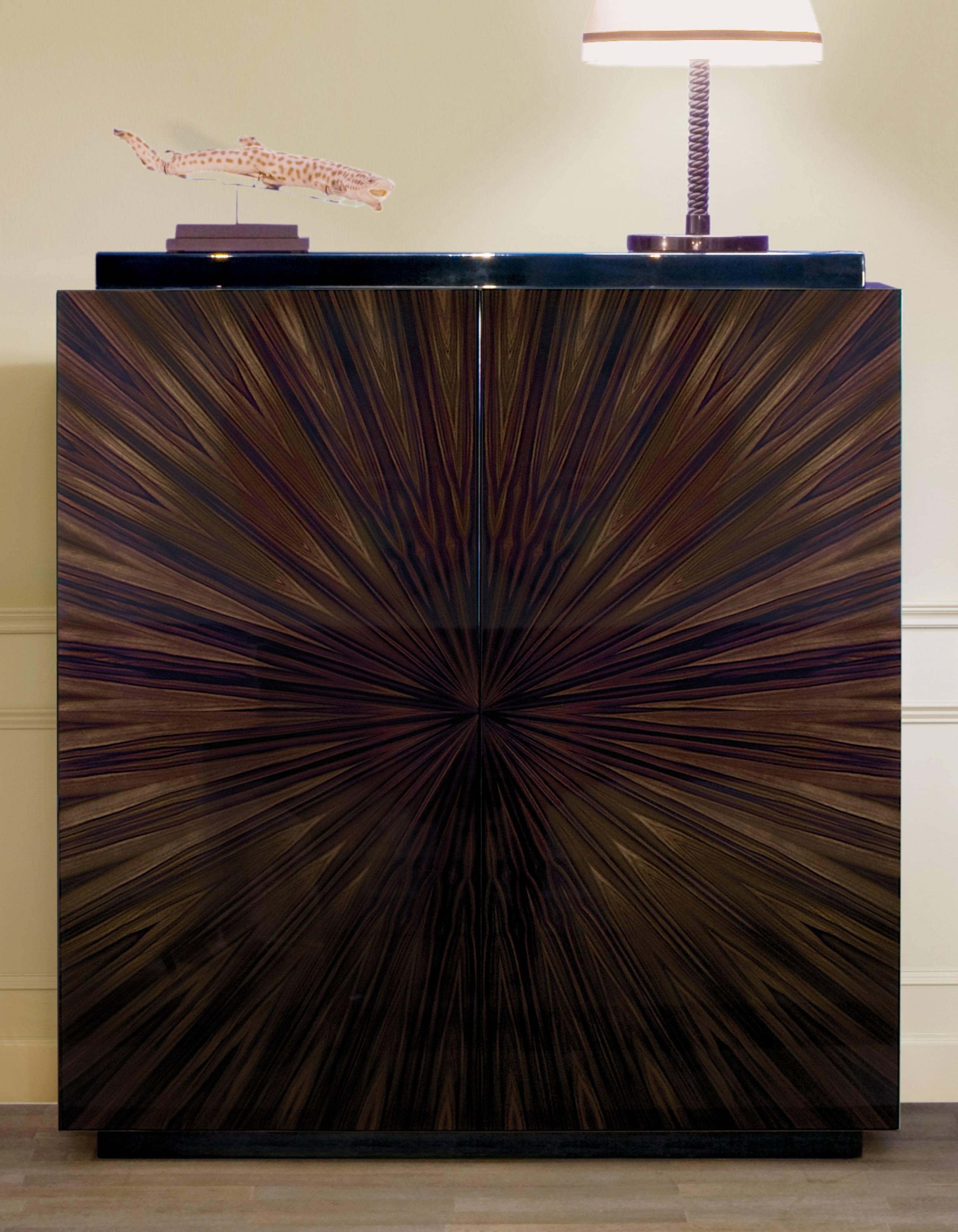 Bringing a dark and mysterious beauty to an interior staple, the Garrison cabinet's ebony Macassar veneer flaunts deep, rich tones.

The sunburst-effect pattern displayed across the front stirs images of one of the most stylish time periods