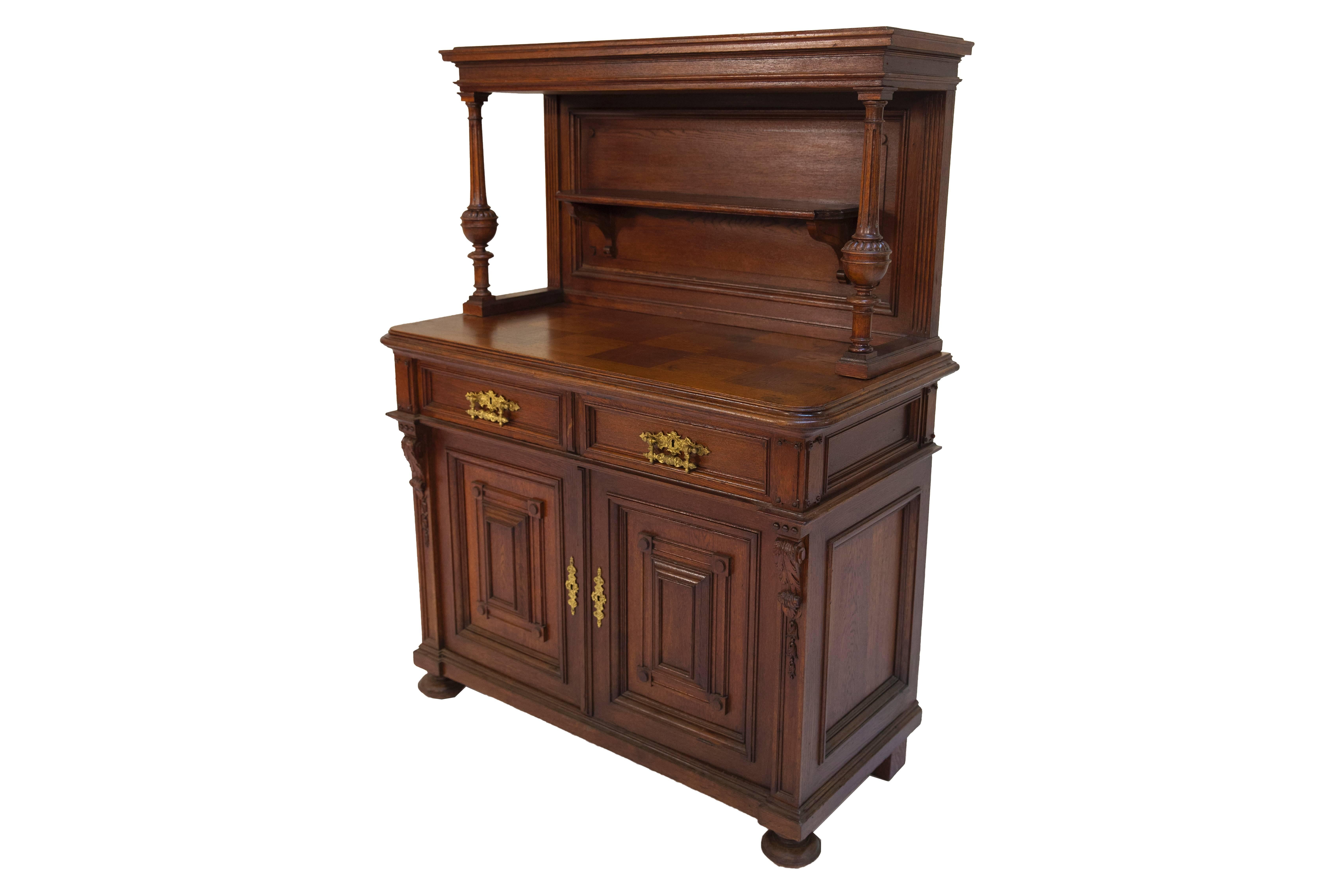 In very good, cared-for condition. The sideboard has two doors and above them, two drawers, and a top unit on the cover plate. The doors are coffered, and their cut-outs are fitted with doubled-on panels. Pilaster columns are attached to the right