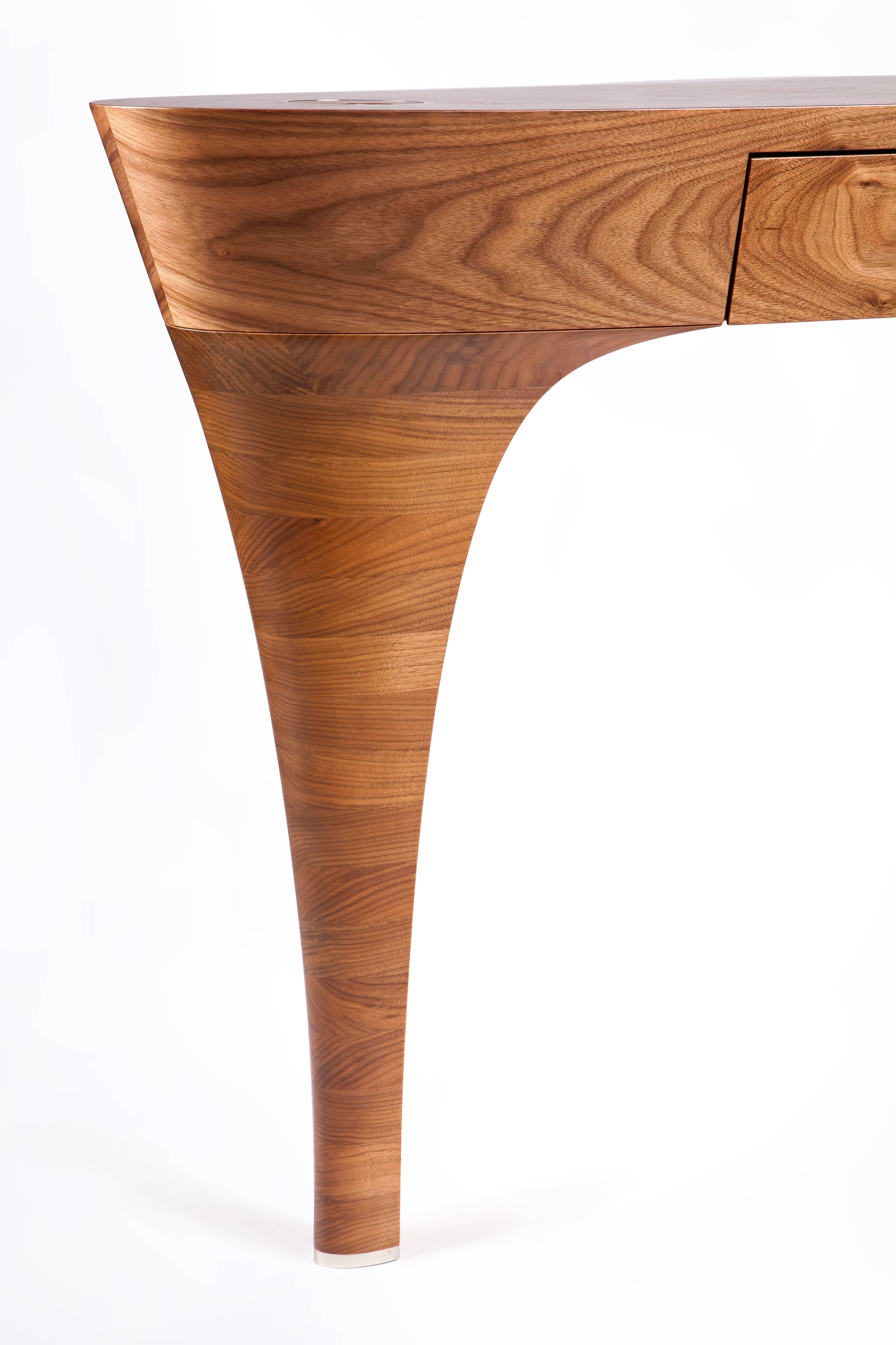 Stiletto by Splinter Works.
French burr walnut, stained Bird’s-eye maple.

Stiletto can function as a desk, console table or dressing table. The curvaceous leg of the table evokes a stacked heel stiletto and is hand-sculpted from solid walnut.