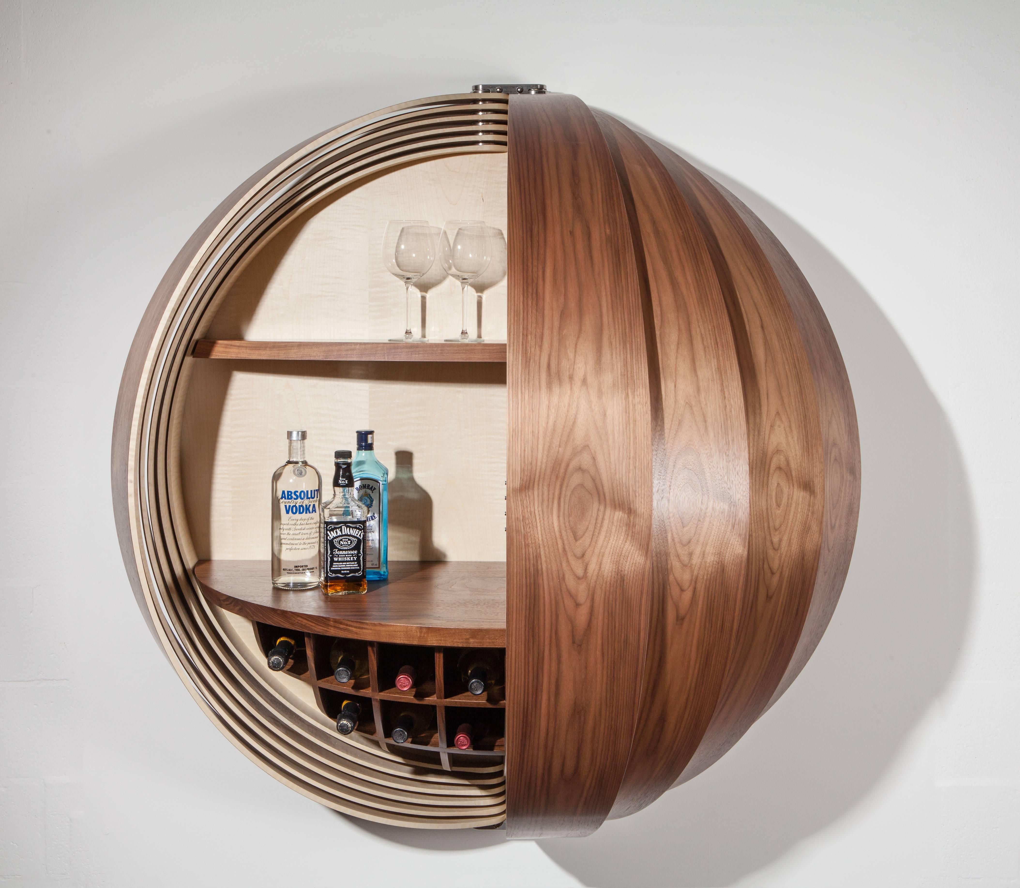 Dime by Splinter Works.
American walnut, ripple sycamore and solid walnut.

Dime is a wall-mounted dry bar, evocative of a spinning coin, it is a dynamic cabinet with a signature Splinter Works twist of illusion and intrigue. The individual