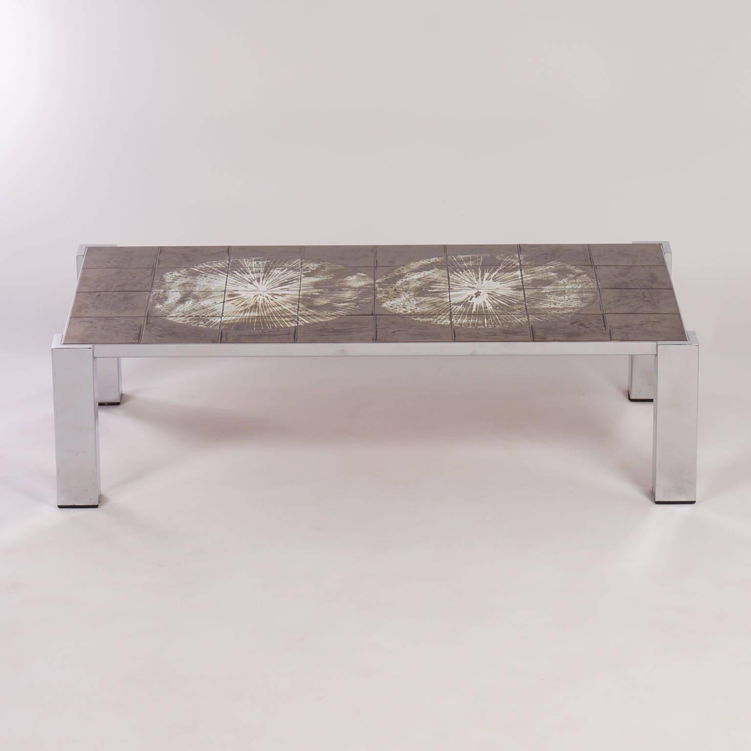 Hand-painted tile coffee table by Belarti from the 1960s. The tabletop of is made of hand-painted ceramic tiles by J. Belarti with colored enamel. Materials: chrome and earthenware tiles. Measurements: H x W x D = 34 x 125 x 64.5 cm.
 