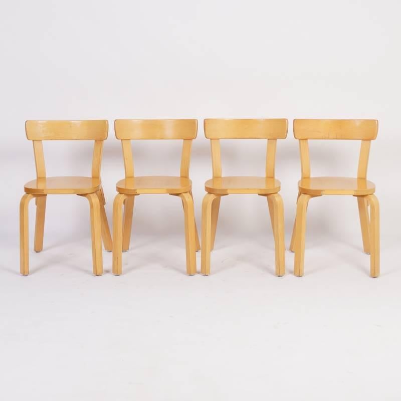 Four dining chairs model 69 designed by Alvar Aalto and manufactured by Artek in about 1933-1935. Unlike Thonet Alvar Aalto bended the wood not with steam, but by means the natural moisture of the Finnish Birch (sawing and water). A rare set that