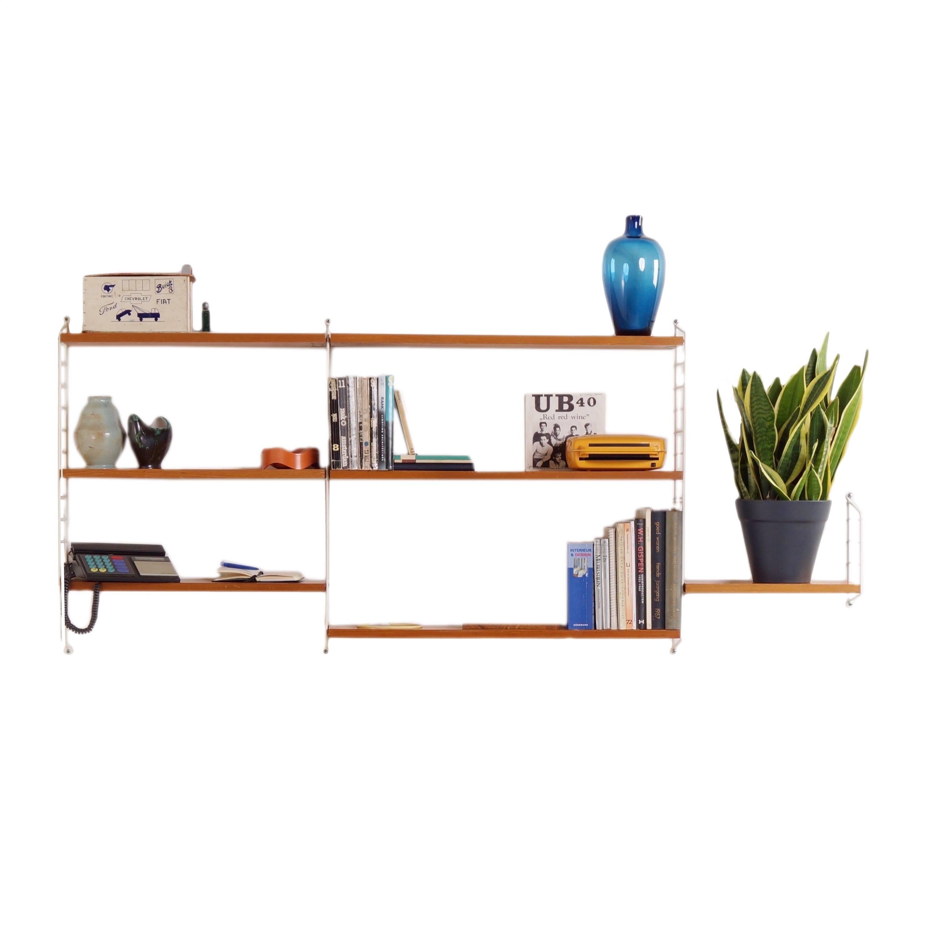 Vintage pine wall unit designed by Nisse Strinning for String Design AB in 1949. This is an original old system dating from 1962 and made in pine veneer. In 1954 this model (String) won a gold medal at the Triennale in Milan. The wall system can be