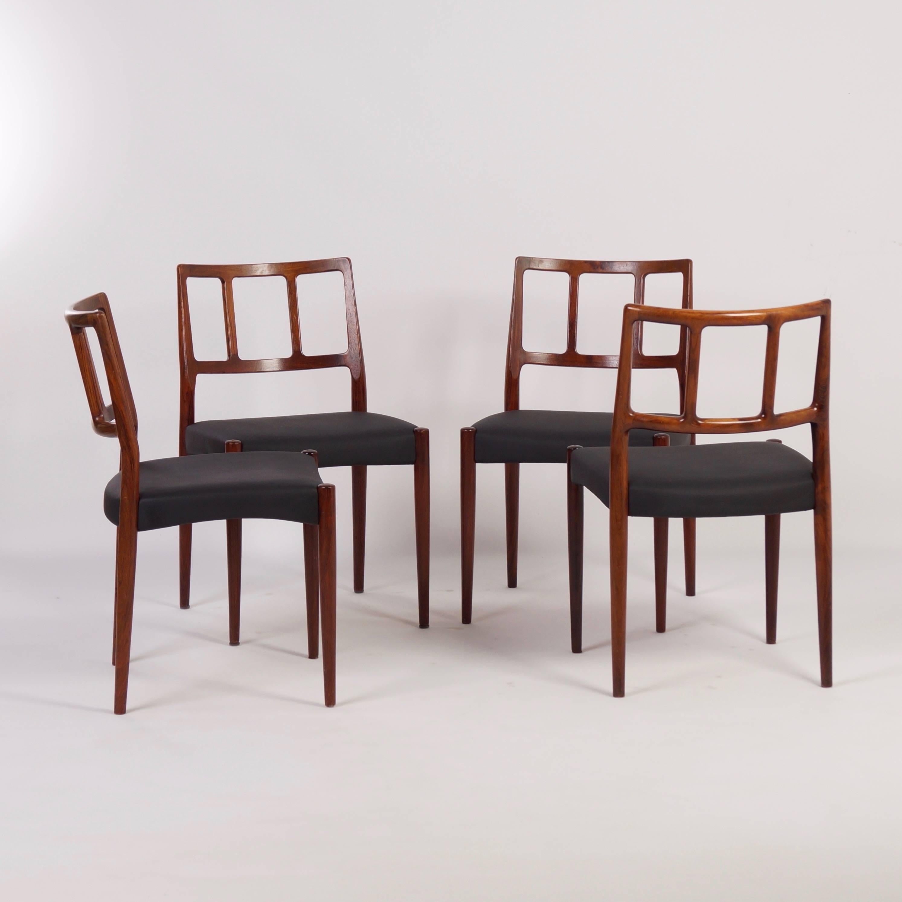 Beautiful set of four Danish dining chairs designed by Johannes Andersen for Uldum Møbelfabrik in about 1960. The chairs are very well made of rosewood with a very fine grain structure and beautiful wood grain connections. Considering its age these