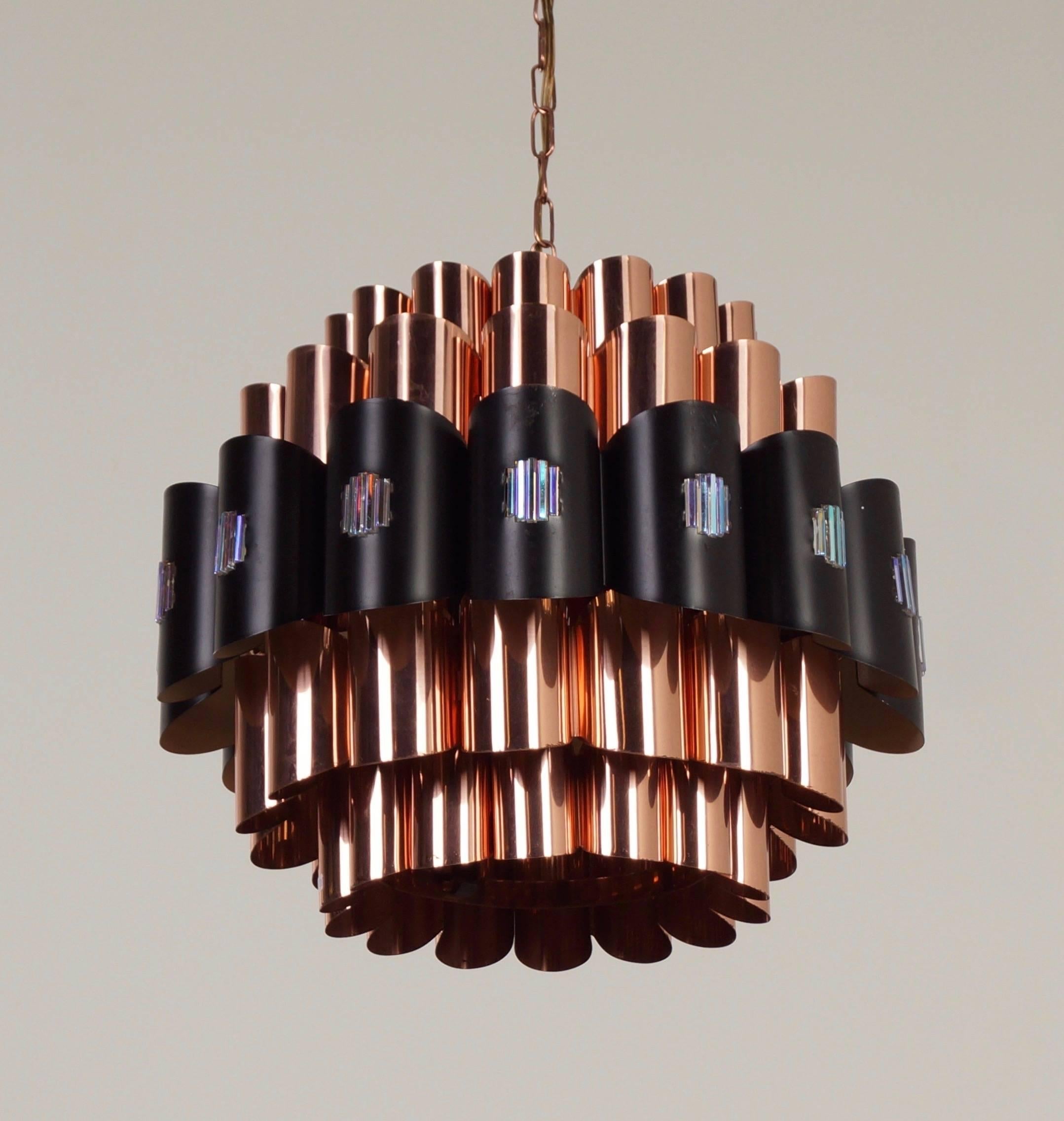 Danish pendant designed by Werner Schou for Coronell Elektro, Denmark, circa 1970. These lamps give a sculptural light effect, which is very characteristic for the lamps by Werner Schou. Material: copper, black lacquered metal and glass pebbles