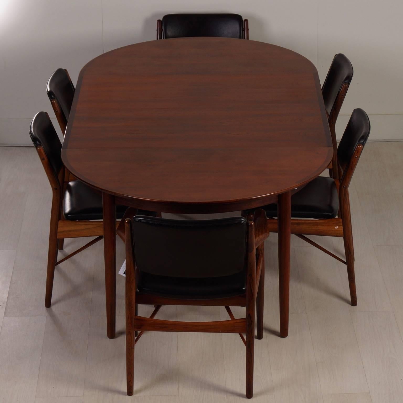 Large Danish dining set designed by Arne Vodder for Sibast from around 1960. This beautiful dining table with six chairs comes from the first owner who bought the set in the early 1960s. This dining set has two extendable leaves. The leaves may