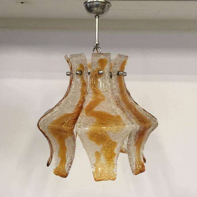 1970s Mazzega Murano hanging lamp from the 1970s. This Italian pendant lamp is made of chromed steel and handblown Murano glass. The handblown Murano glass is frosty, clear and a little bit orange / brown. Because of that this chandelier gives