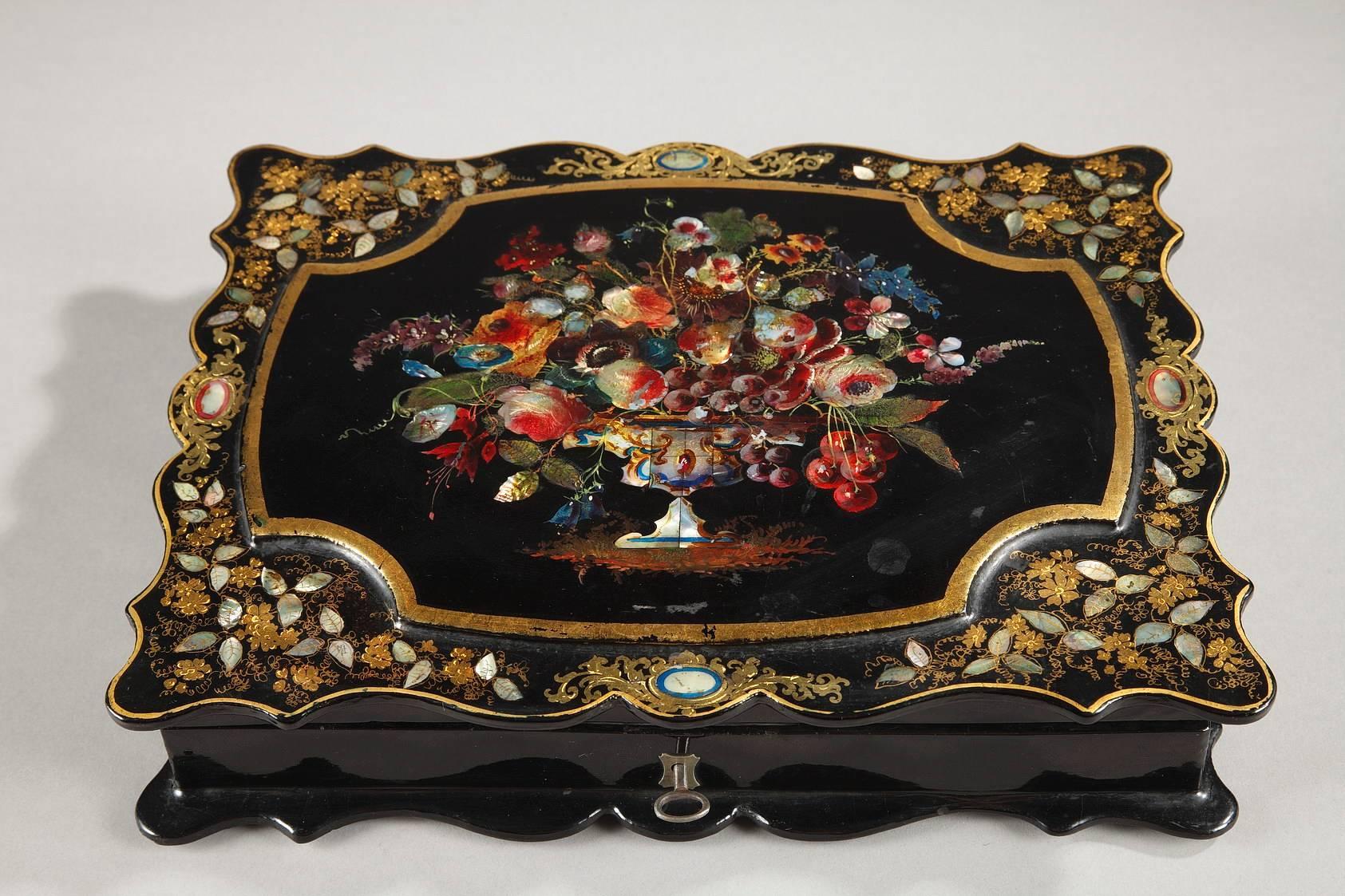 Napoleon III papier mâché́ box for card games with its original key. The lid is richly decorated with a multicolored bouquet of flowers in a central medallion with a gilt frame. It is surrounded by gilt, flowering branches with mother-of-pearl