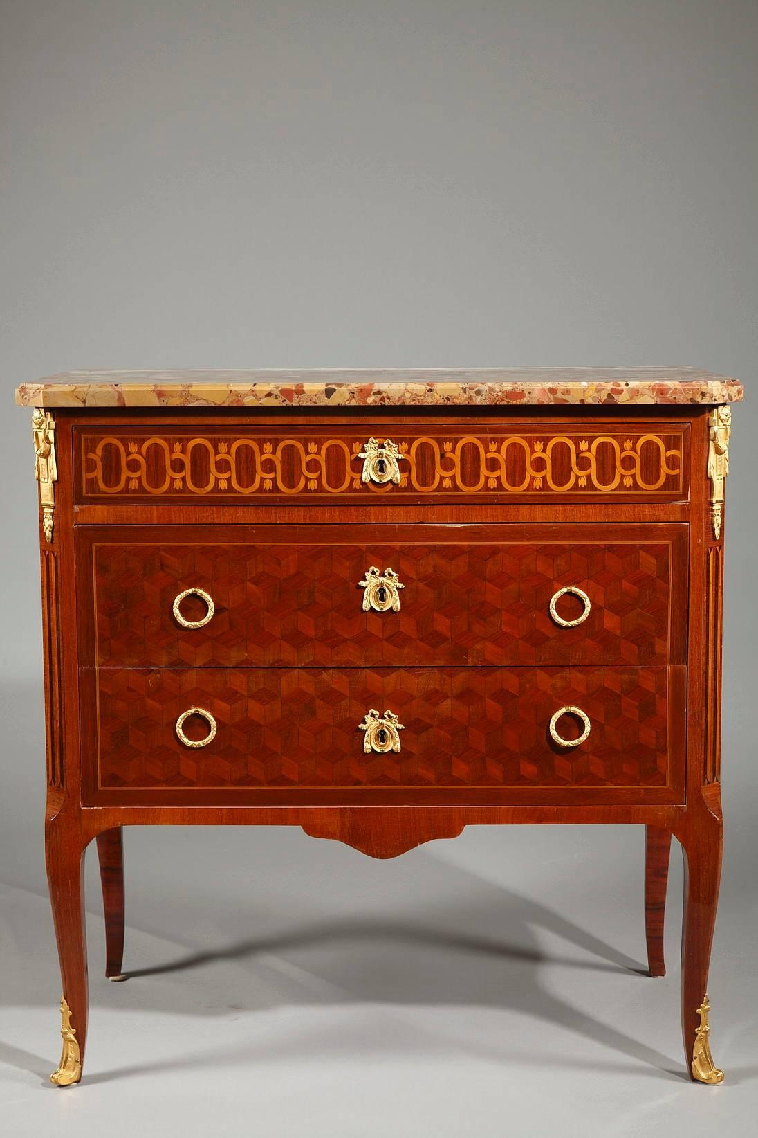 Late 19th century transitional style marquetry commode with three drawers. The set is topped with a Breche d’Alep molded marble top with canted corners. A marquetry motif of interlacing and flowers runs under the marble top across the sides and top