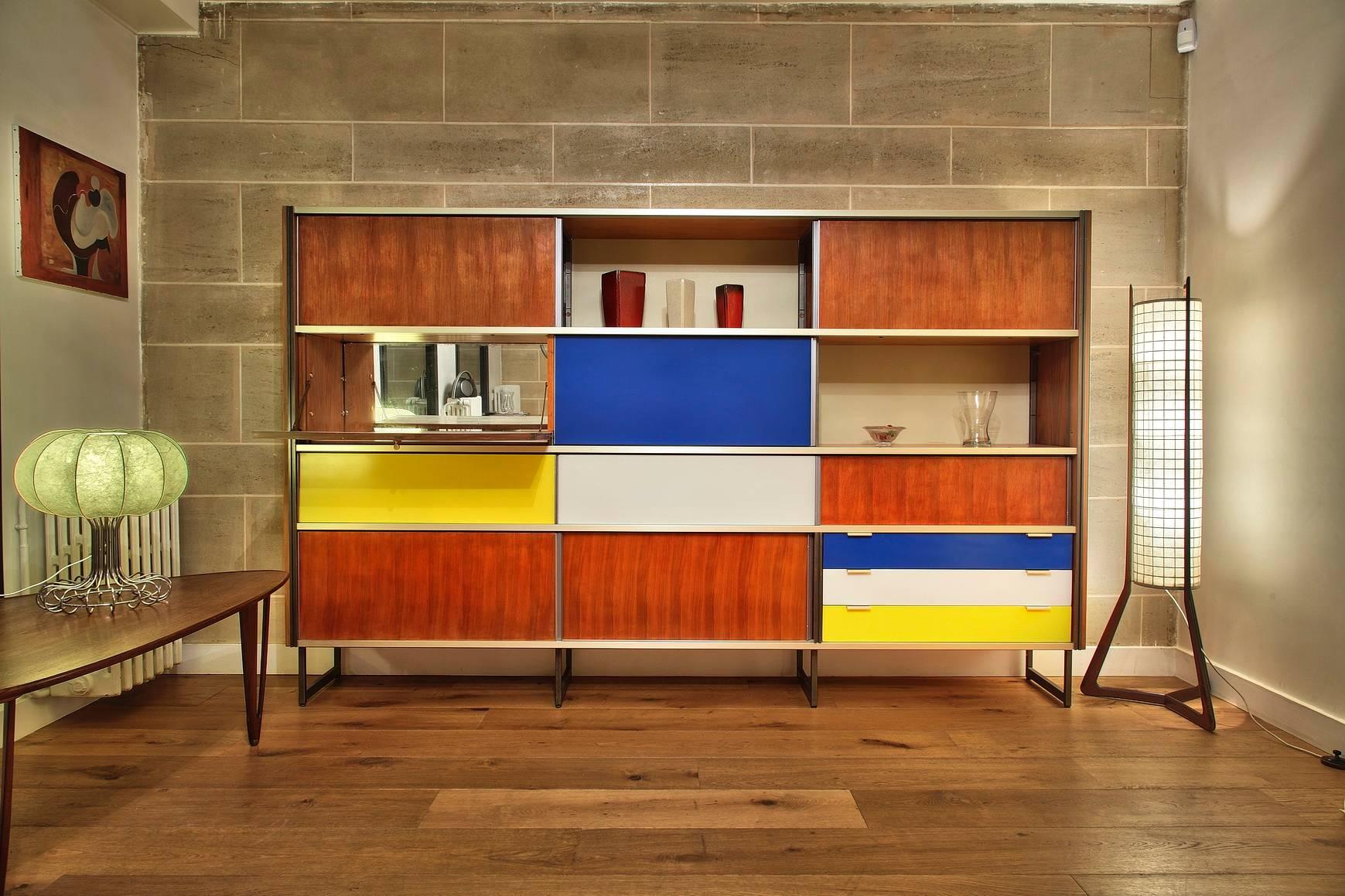 Modernist 1950s storage cabinet by Georges Frydman in aluminum, blue, yellow and white lacquered rosewood. It is composed of a set of shelves and three drawers. Edited by EFA,

circa 1950.

Dimensions: W 106.3 in, D 17.5in, H 66.5in
Dimensions: L