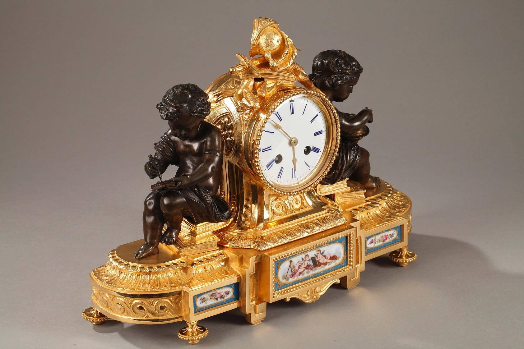 Napoleon III ormolu mantel clock in Louis XVI style. The clock features military motifs as well as two patinated bronze putti sitting on books, which represent the arts. The oval base is decorated with three porcelain plates depicting two winged