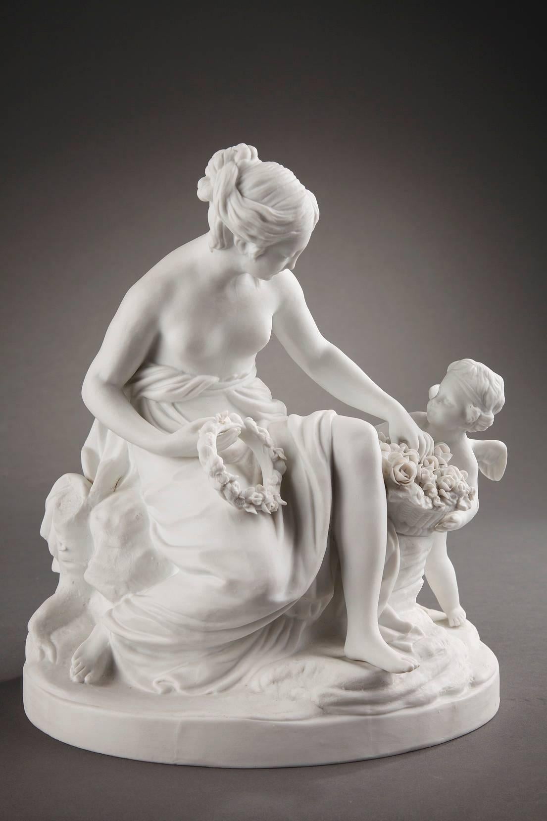 Hard-paste biscuit porcelain depicting a young woman and cupid. The young woman is sitting on a rock that is nestled between two tree trunks. Next to her, a winged cupid, carrying his quiver, holds a basket filled with flowers that the woman is