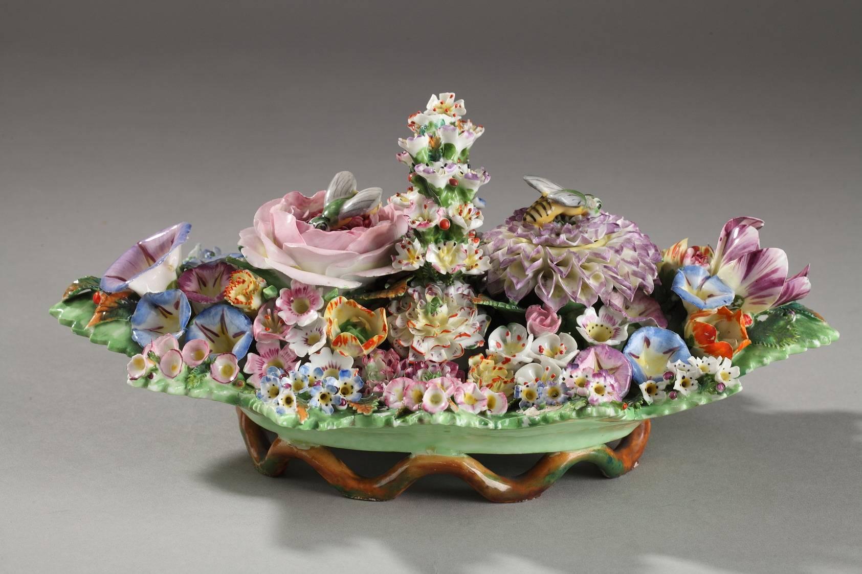 Multicolored porcelain inkwell in the shape of a basket of flowers. It is covered in a variety of textured flowers: Violets, tulips, chrysanthemum, roses, and several varieties of petunias. This piece is very representative of the original and