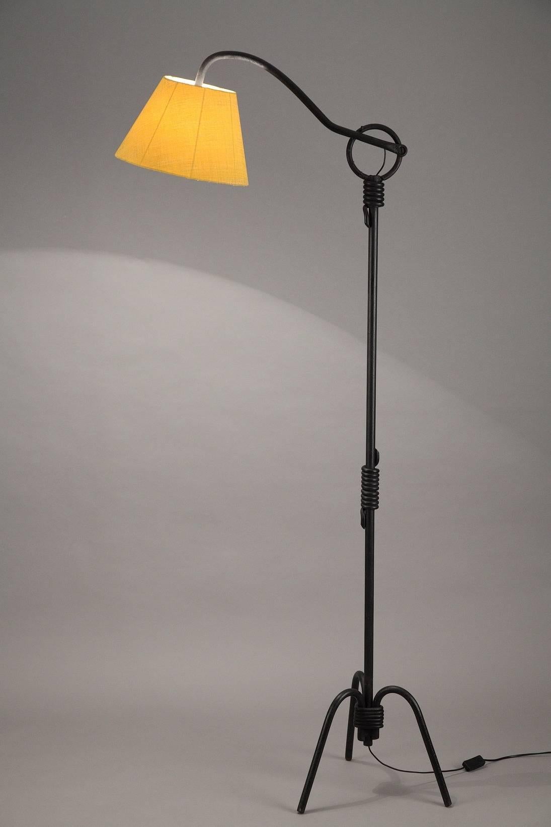 Black lacquered iron tripod lampstand after a model by Jean Royère, with an adjustable arm of light (five positions). Restaured yellow lampshade.

Jean Royère (1902-1981) was a French interior designer. From 1931, he learnt his new trade in the