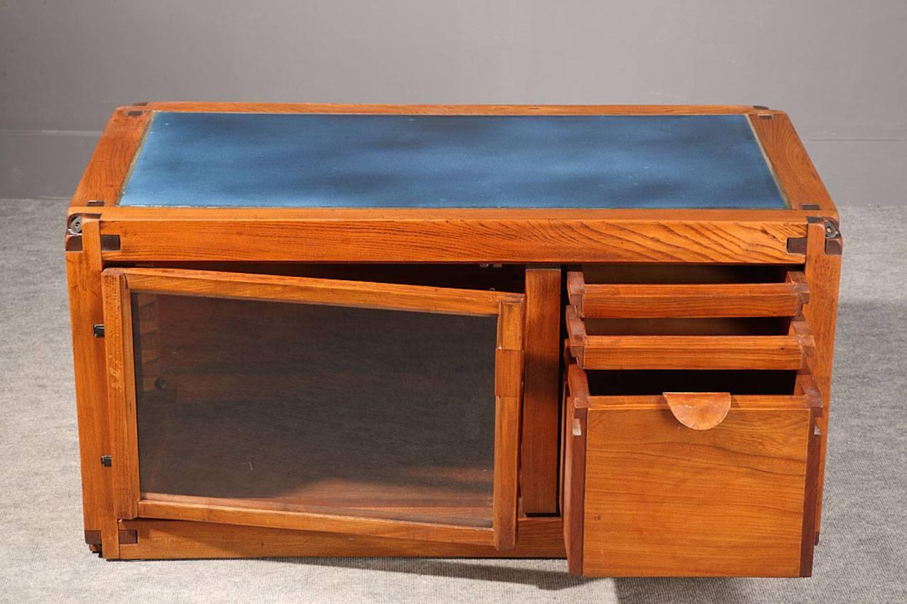 1960s Pierre Chapo massive elm buffet with three drawers and one storage. The peculiarity of this piece of furniture is the blue enameled lava plate covering the top of the buffet. The wood work and the mounting are of a very good quality.

Pierre