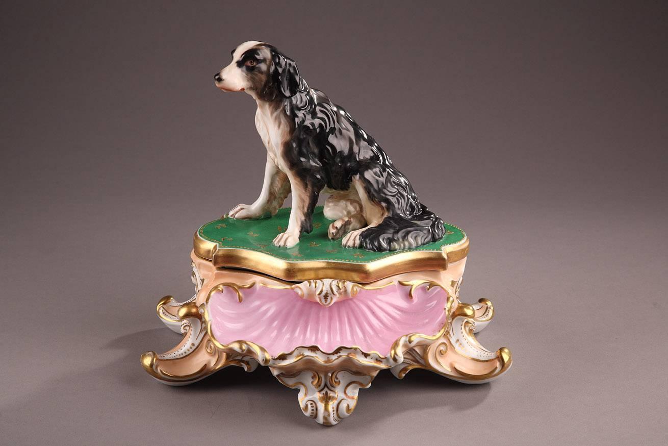 Inkwell made of porcelain from Paris in Jacob Petit’s style. This unusual inkwell is composed of two parts. The bottom, which has five scroll-shaped feet, has two wells for ink and sand, and its front has a shell-shaped basin. On the upper lid rests