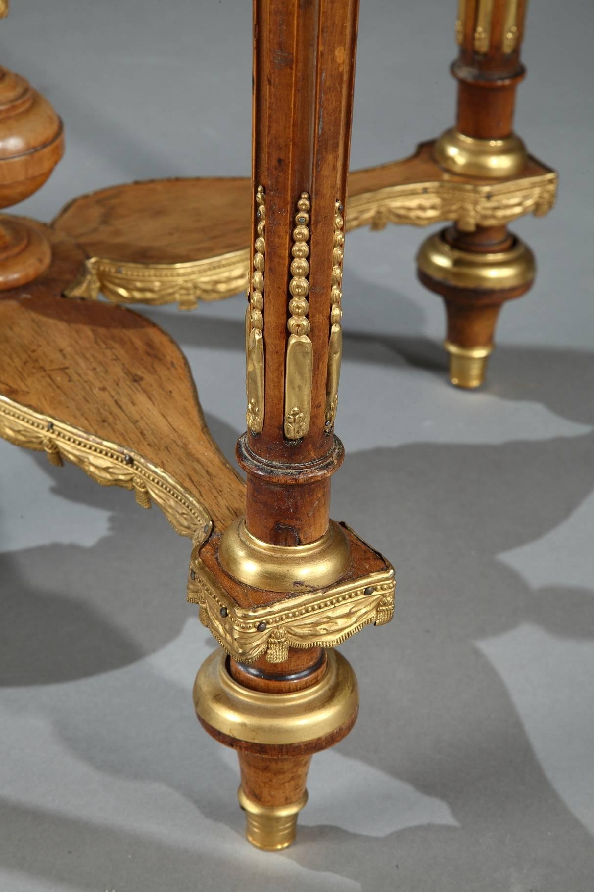 Napoleon III ash gueridon table with bronze and brass accents in Adam Weisweiler (German, 1746-1820) taste. This Louis XVI-style gueridon is composed of a circular, royal-red marble top ringed with an openwork rim. The body of the table is