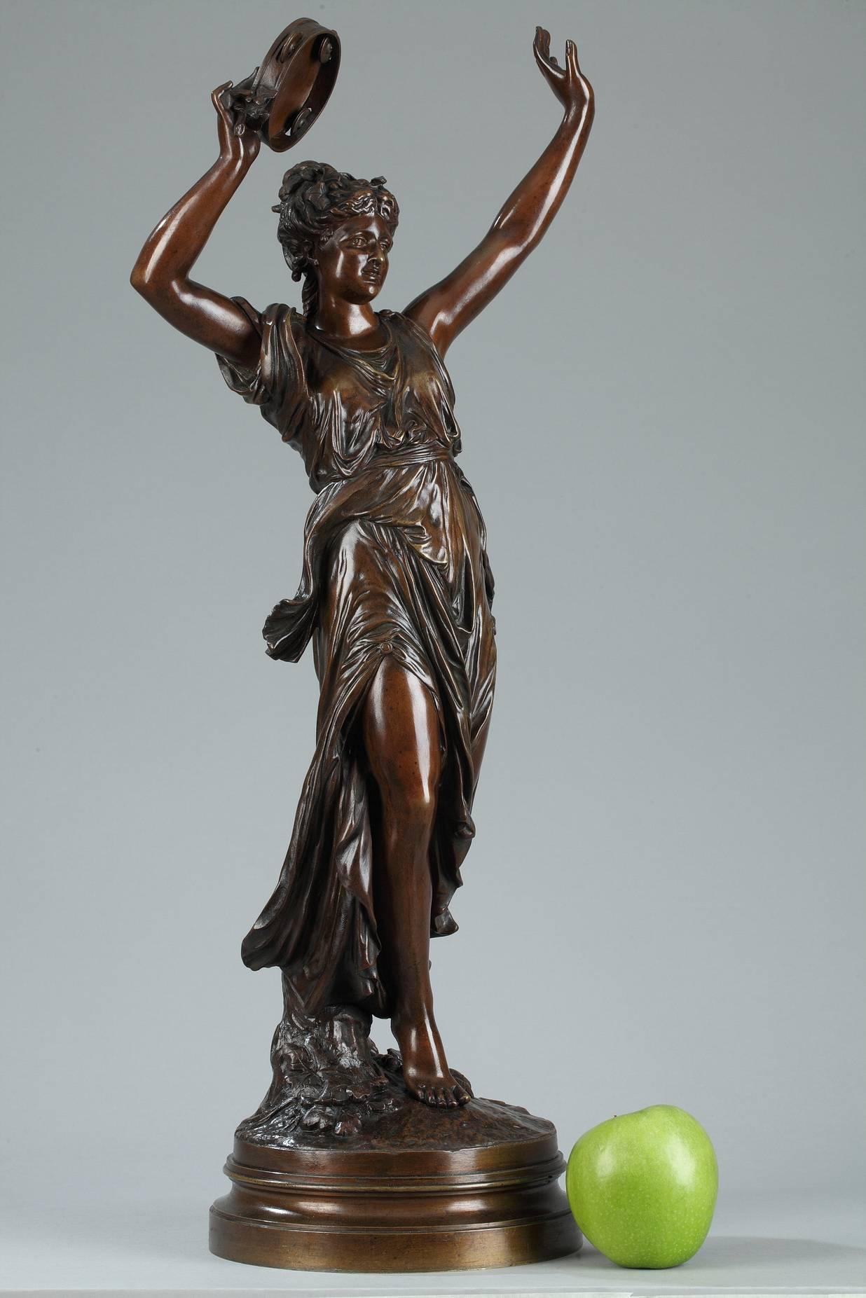 Patinated bronze sculpture featuring a dancing Bacchant playing a tambourine. This work by Gregoire with a musical theme joins his other similarly-themed works such as L'Allégro, Mozart Enfant (Mozart as a Child) and Un Artiste au XVIIe Siècle