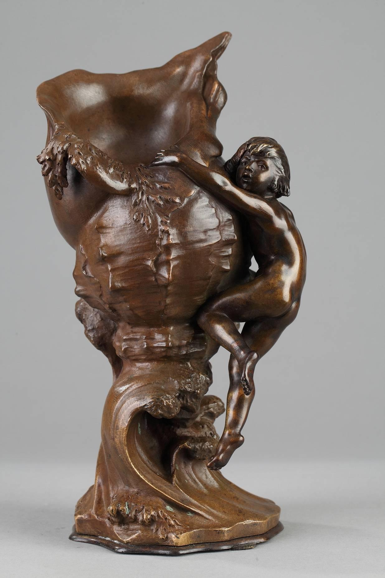Late 19th century pair of bronze vases with brown patina depicting a young boy and girl climbing up shells, which are supported by waves. Both pieces are signed on the base: 