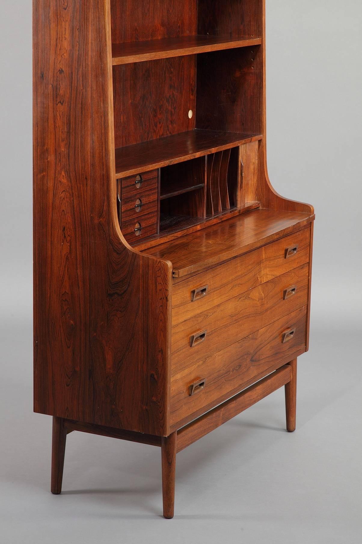 A rosewood secretaire bookcase by Johannes Sorth with adjustable upper shelves and three lower drawers. The tambour doors roll back to reveal three small drawers, mailing slots and two small cubbyholes. Manufactured by Bornholms Mobelfabrik. Good