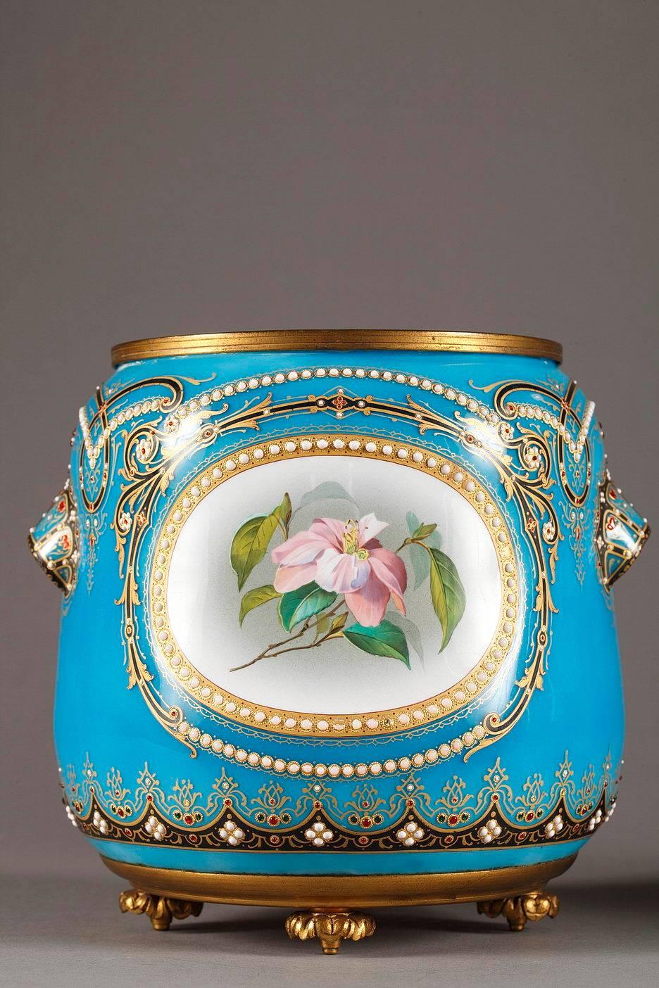 Late 19th century pair of jardinières in blue enamel from Bresse. Multicolored medallions depicting delicate flowers are framed by white and red enamel beads and gilded arabesques. Each pot has two small handles that are richly decorated with