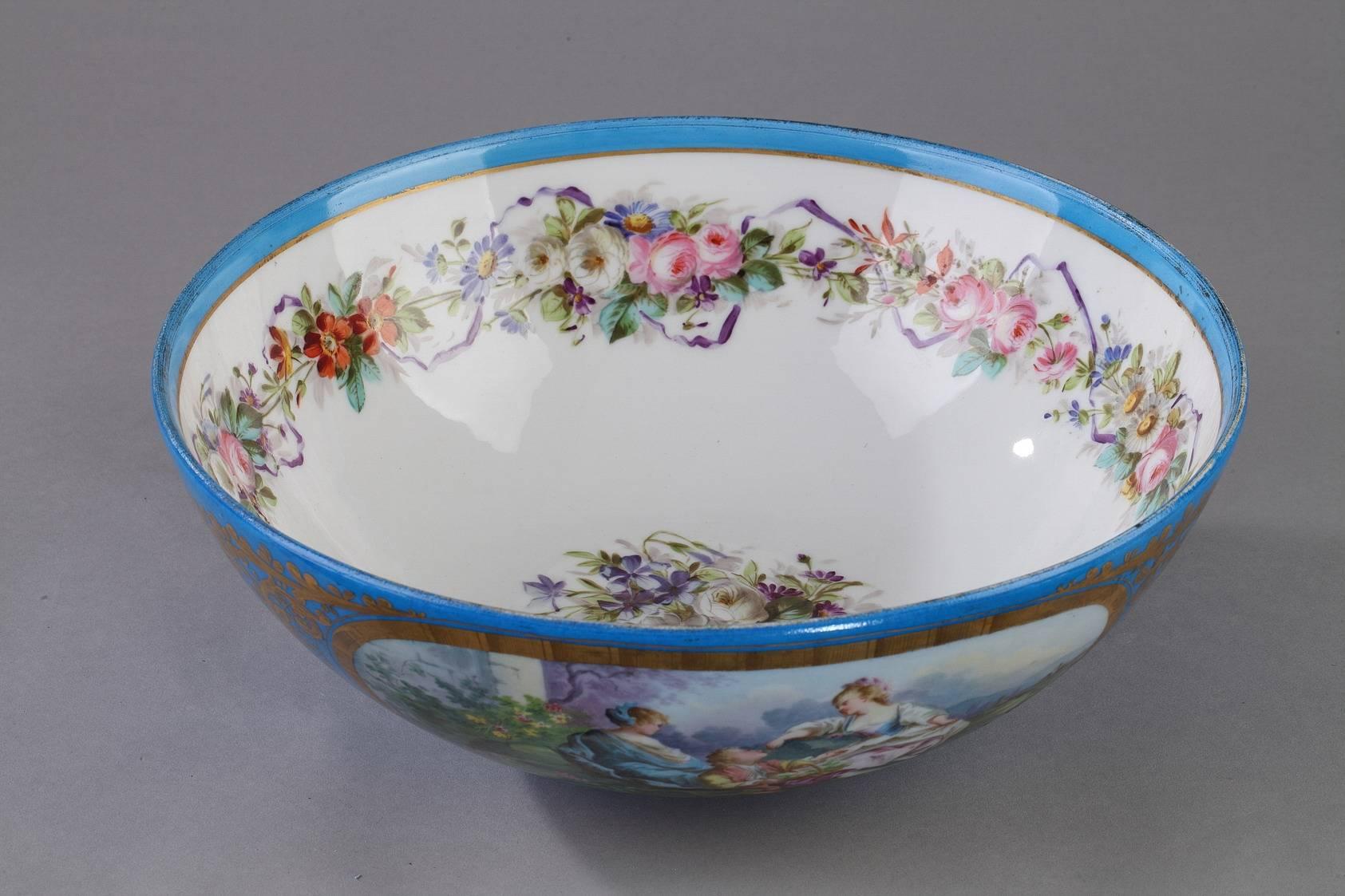 Large porcelain bowl embellished with large medallions featuring, on one side, gallant figures in a landscape, and on the other side, an overflowing bouquet of flowers. The medallions are framed in foliage painted with gold. The interior of the bowl