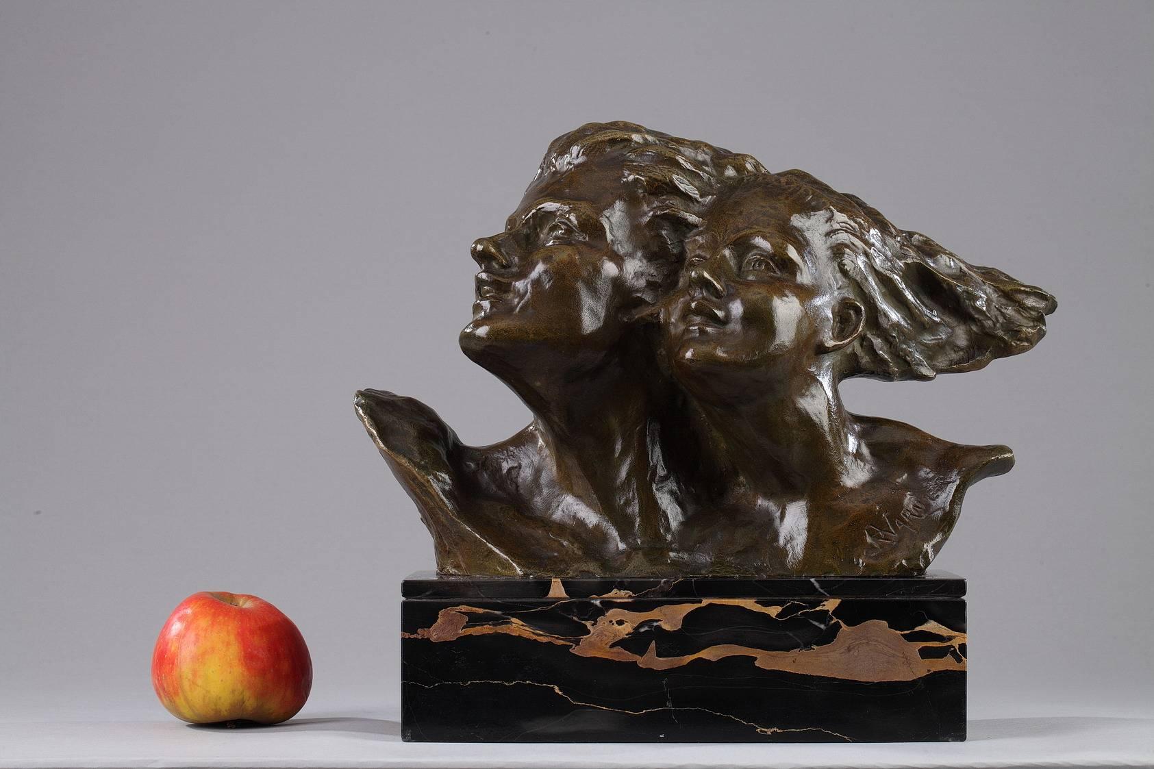 Bronze sculpture with nuanced, brown patina by René André Varnier (active during the early 20th century). It features a couple in love with their hair flowing behind them as the face the wind together. It is set on a Portoro marble base, a type of