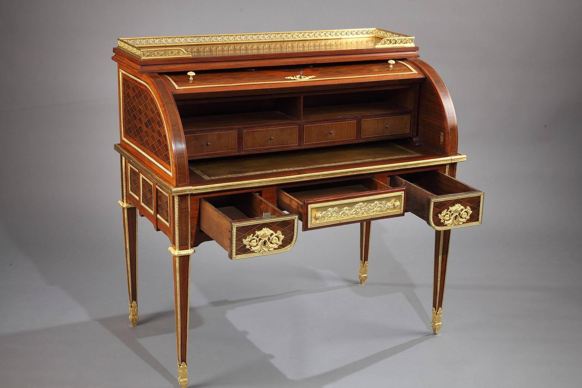 Louis XVI style rolltop writing desk with marquetry latticework pattern. The front of the desk features three drawers that are 16.5 in (42 cm) deep. The rolling cover is embellished with a large marquetry medallion featuring symbols of Poetry. It