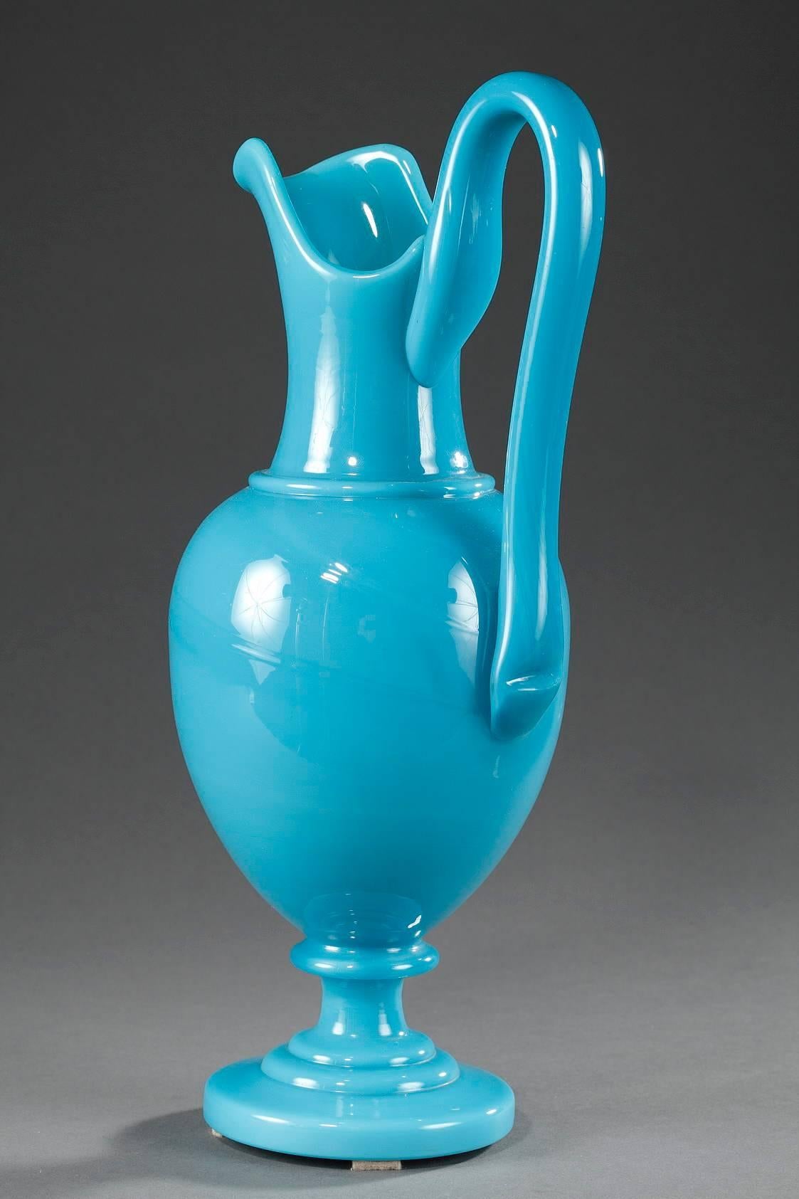Charles X light-blue opaline ewer with a high handle and resting on a circular foot. Its delicate color and the purity of its elegant form are representative of opaline glass production during Charles X ‘s reign. Very good condition,


circa