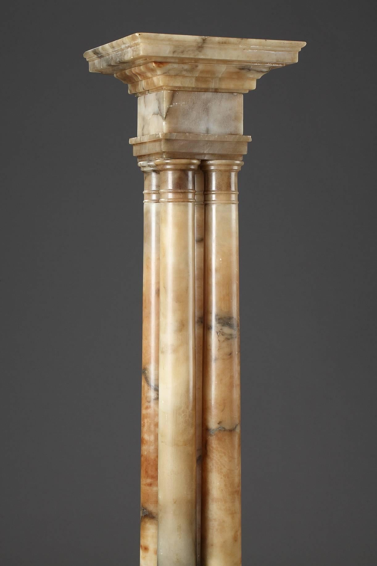 Display column in alabaster. The stem is composed of four columns decorated with Doric capitals and moulding bases. It is set on a high, square, terraced base, 19th century period. Good general condition, with light chips,

circa 1860
Dimension: