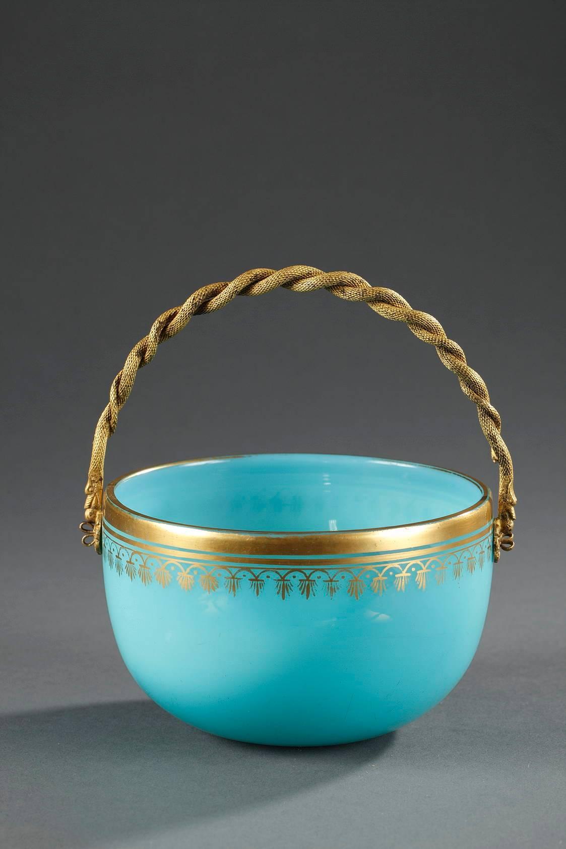 Basket-shaped cup in blue opaline decorated with gilded festoons and stripes. The gilded and sculpted bronze handle is in the shape of two intertwined snakes. Intricate chasing work.
 

circa 1820
Dimension W 5.1 in, D 4.7in, H 3 in.
Dimension