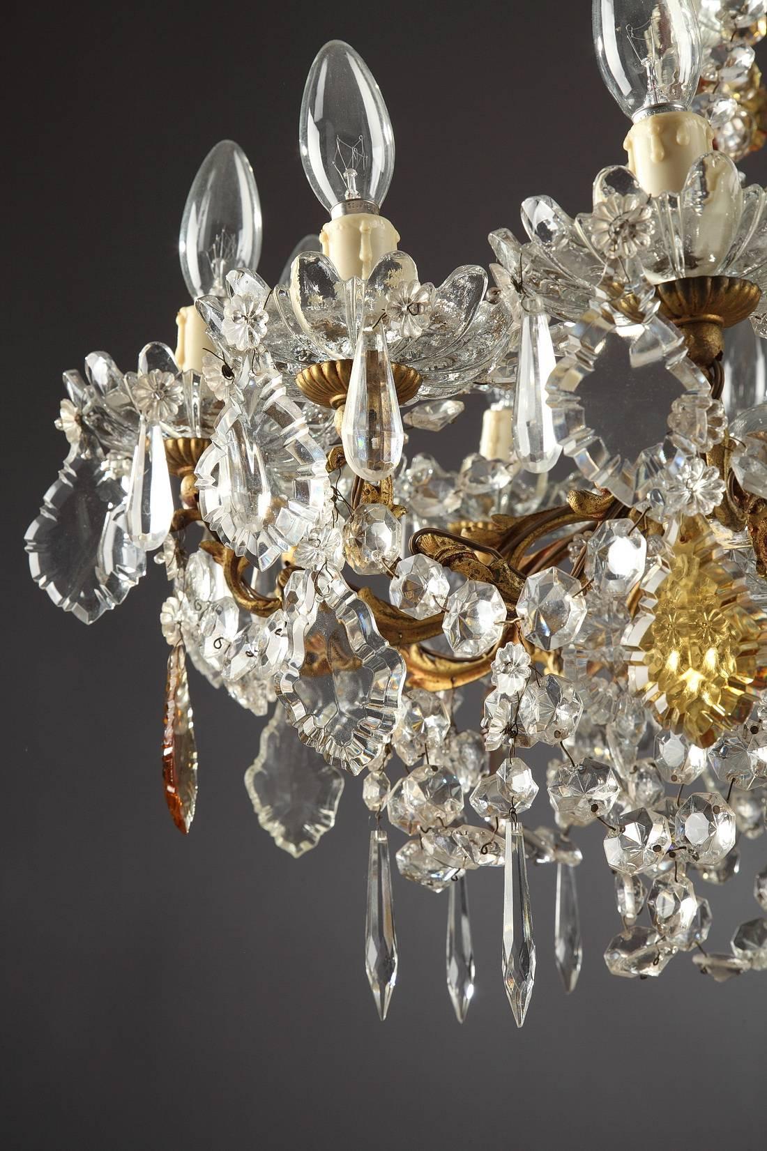 Napoleon III chandelier with 12 curved arms of light decorated with garlands, drop-hung drippans and slice-cut drops in amber and transparent crystal. Gilt and chiselled bronze mounts, embellished with foliage. Electrified,

circa