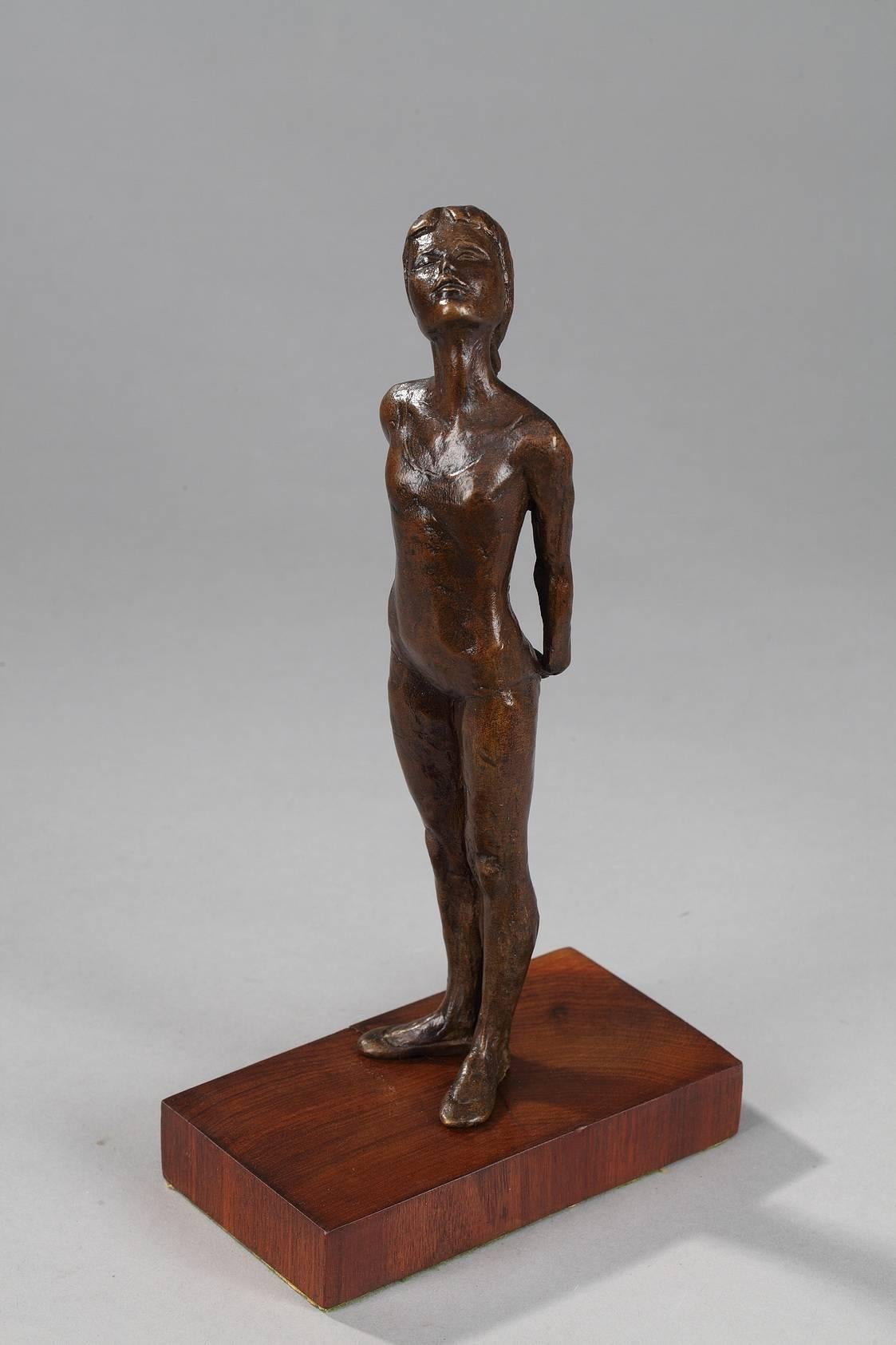 Royal Copenhagen S.G. Kelsey patinated bronze figurine depicting a young ballet dancer on a wood base. She is looking up and has a very long braid down her back. Signed on the hip : SGK. Metal plate on the back of the base, marked: S. G-Kelsey '75,
