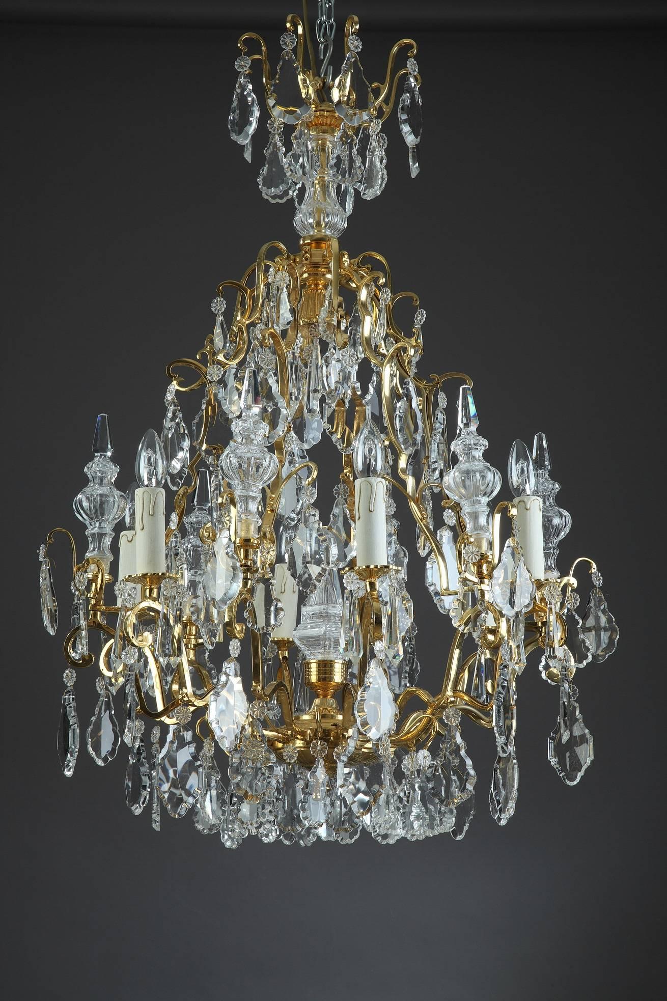Pair of chandeliers with six curved arms of light and 6 daggers, richly decorated with garlands, drop-hung drippans and slice-cut drops in transparent crystal. Gilt and chiseled bronze mounts, embellished with foliage. Napoleon III period.