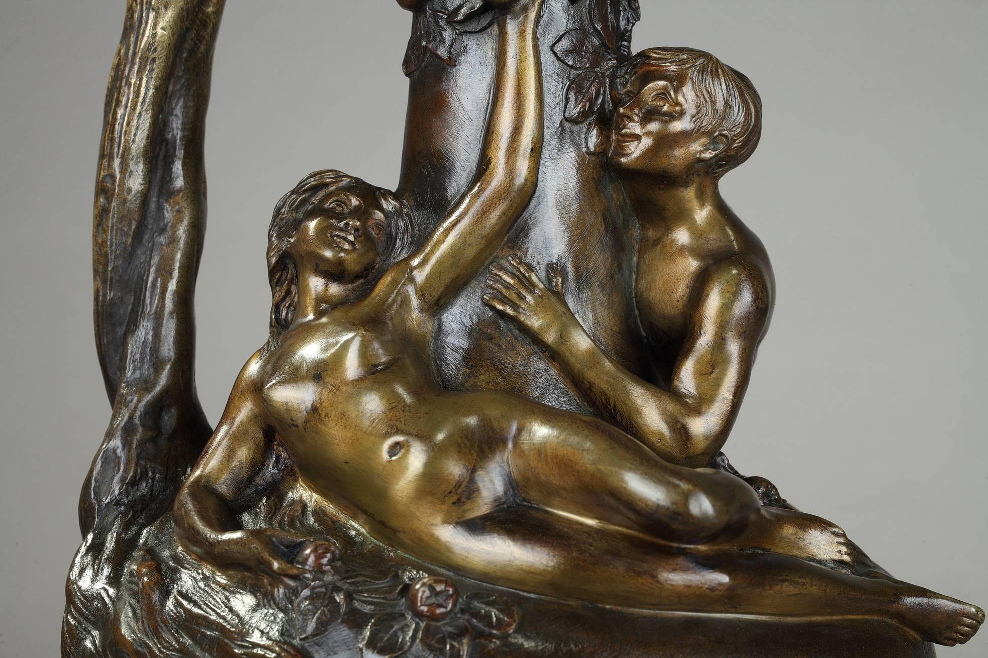 Patinated bronze ewer featuring Adam and Eve in the Garden of Eden. Eve is lying on the paunch of the ewer, while picking the forbidden fruit from the tree of good and evil. The trunk of the tree forms the handle. Signed on the paunch: Victor