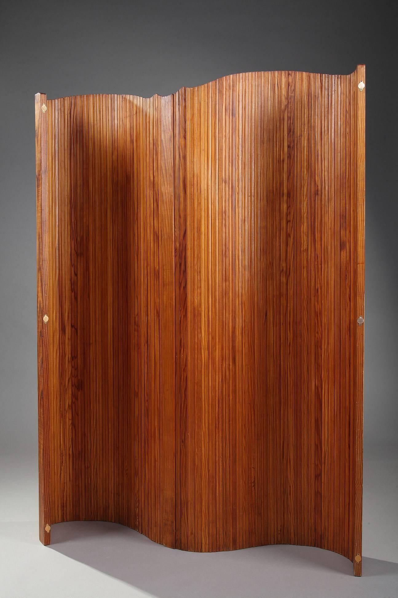 Articulated varnished wooden screen produced by Baumann, a French manufactory (1901-2003), famous for its chairs and other furnitures in wavy wood. Pine wood lamels mounted with flexible metal wirings. The screen can be adjusted according to wish.