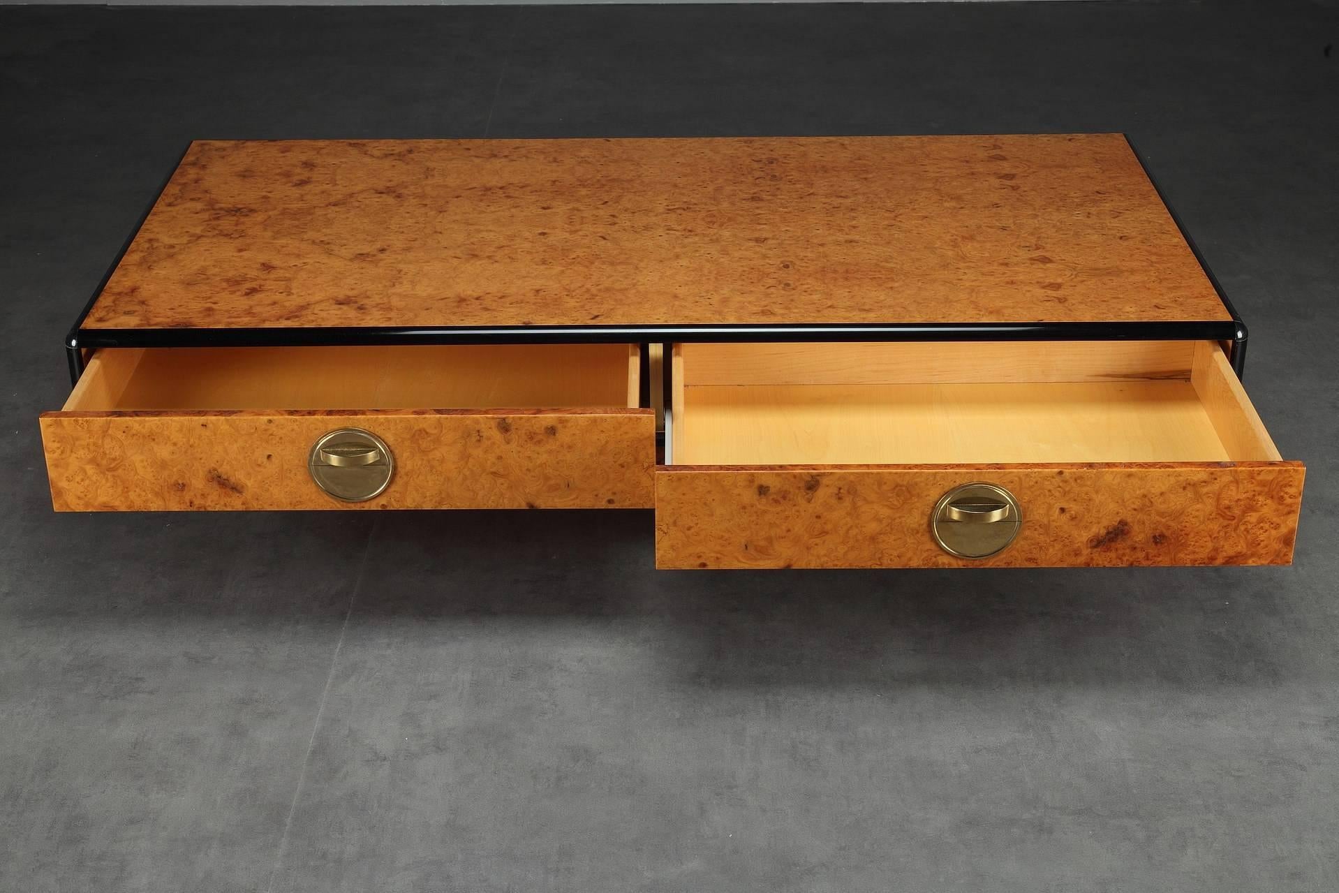 Rectangular burr elm veneer coffee table with black lacquered trims and 2 drawers provided with brass handles, resting on a large central foot. Attributed to Jean-Claude Mahey. Good vintage condition with very light scratches.


circa