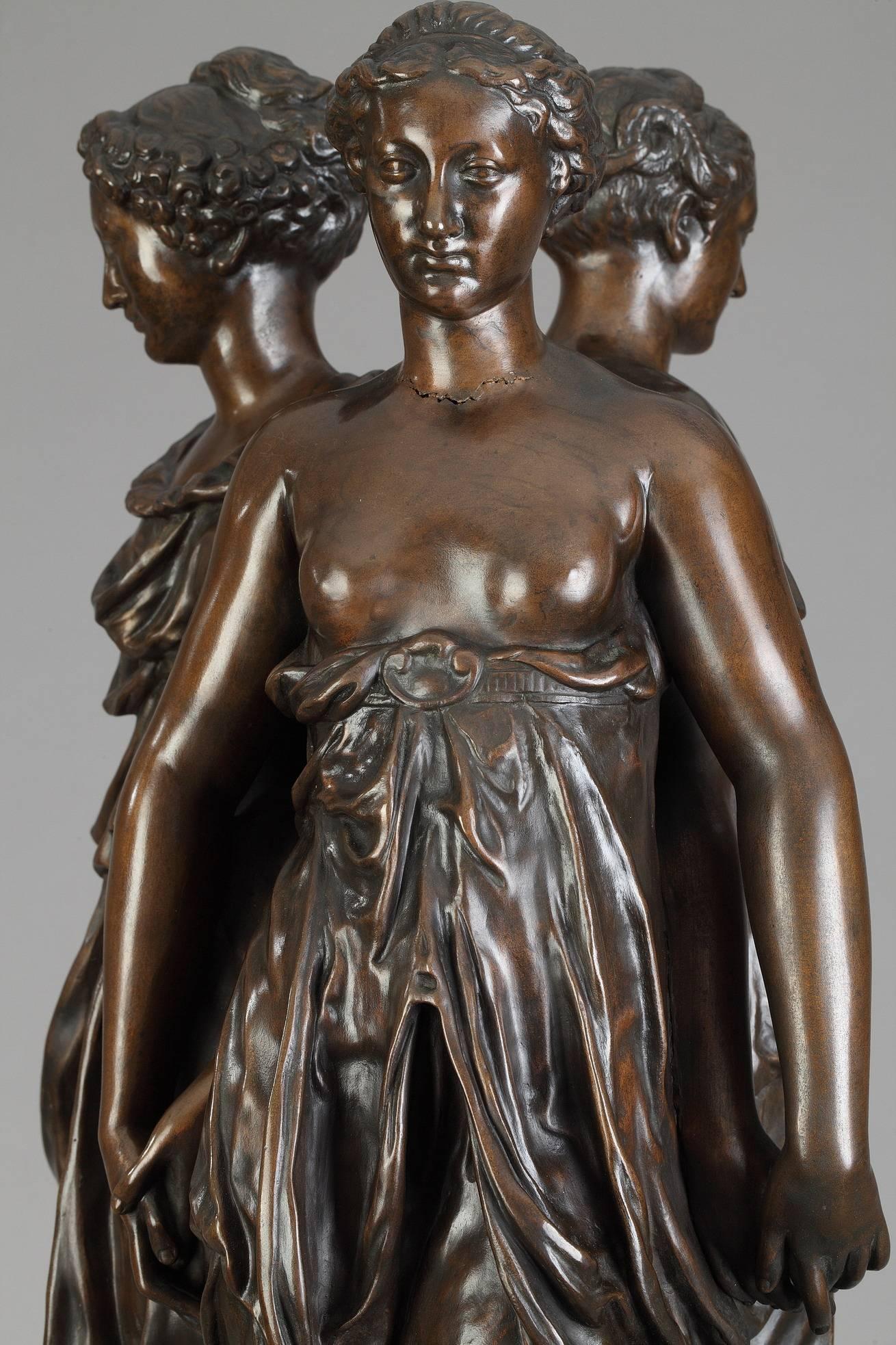 Large patinated bronze group of the Three Graces after Germain Pilon (Paris, 1528-1590). It features three young women standing back to back with their hands clasped seem to be slowly performing a round dance. The theme, the light tunics, the