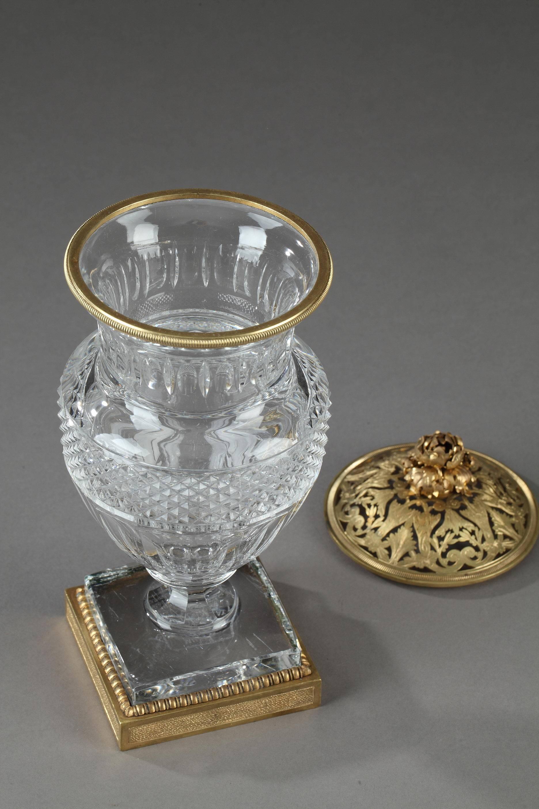 Baluster vase in cut crystal decorated with straight cuts and diamond points. The openwork cover, in gilt bronze, is embellished with acanthus leaves, intertwined scrollwork, and is topped with a floral-shaped handle. Marked on the base: Musée des