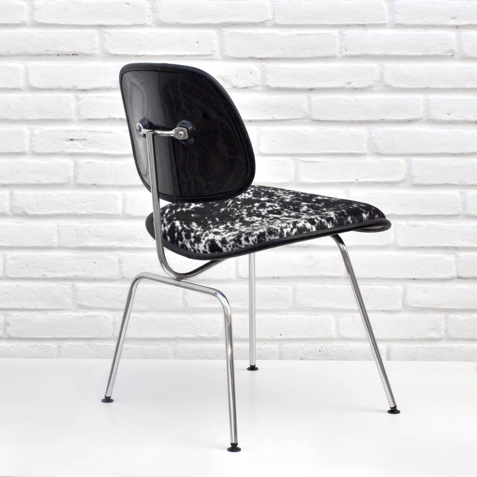 A classic DCM chair designed by Charles and Ray Eames for Herman Miller. The chair is upholstered in black and white cowhide with black leather trim, a steel body and black feet.

Chair is marked underneath.