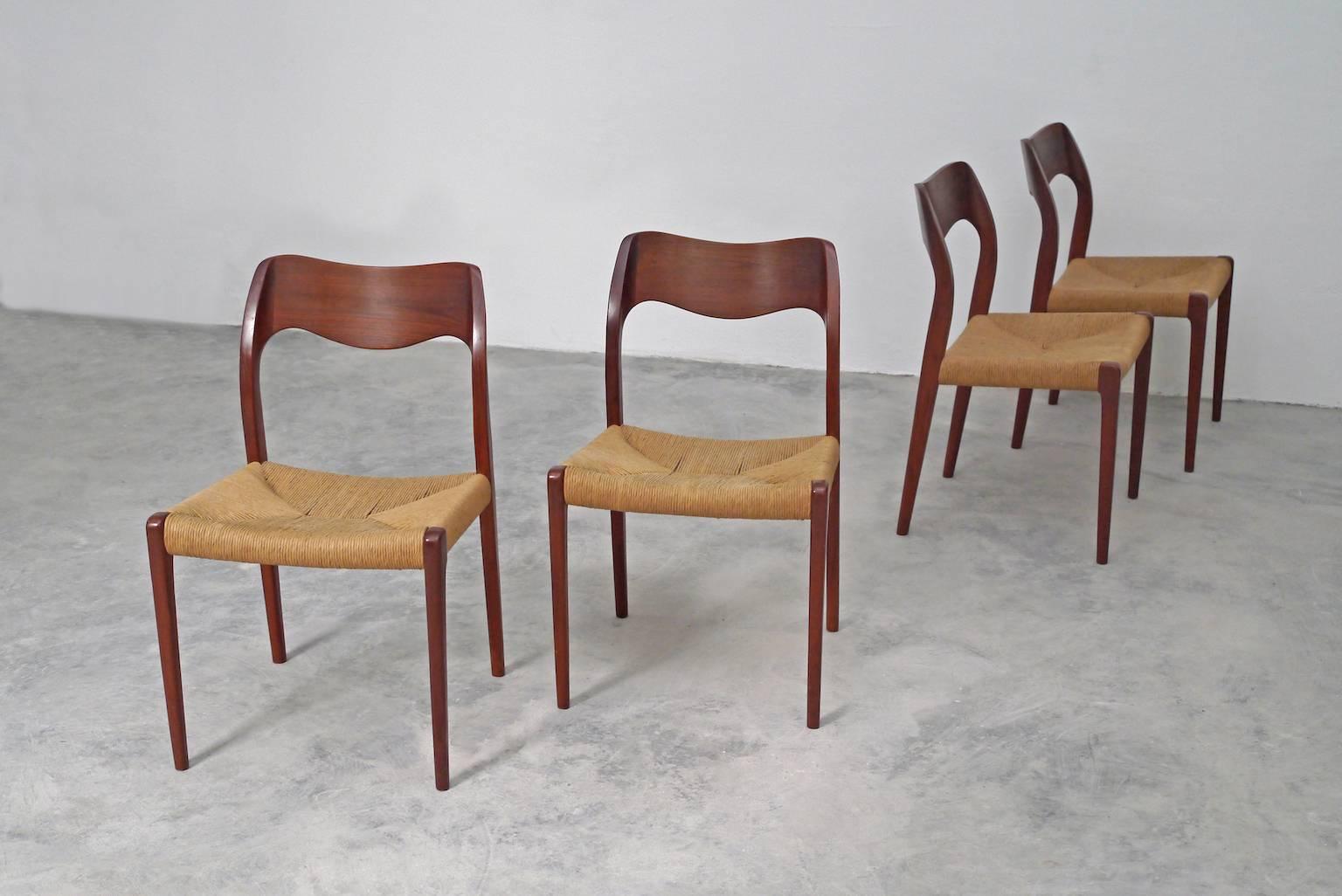 This set of four 'model 71' dining chairs are an extremely graceful and comfortable design. Each teak chair has woven cord seating. 

   