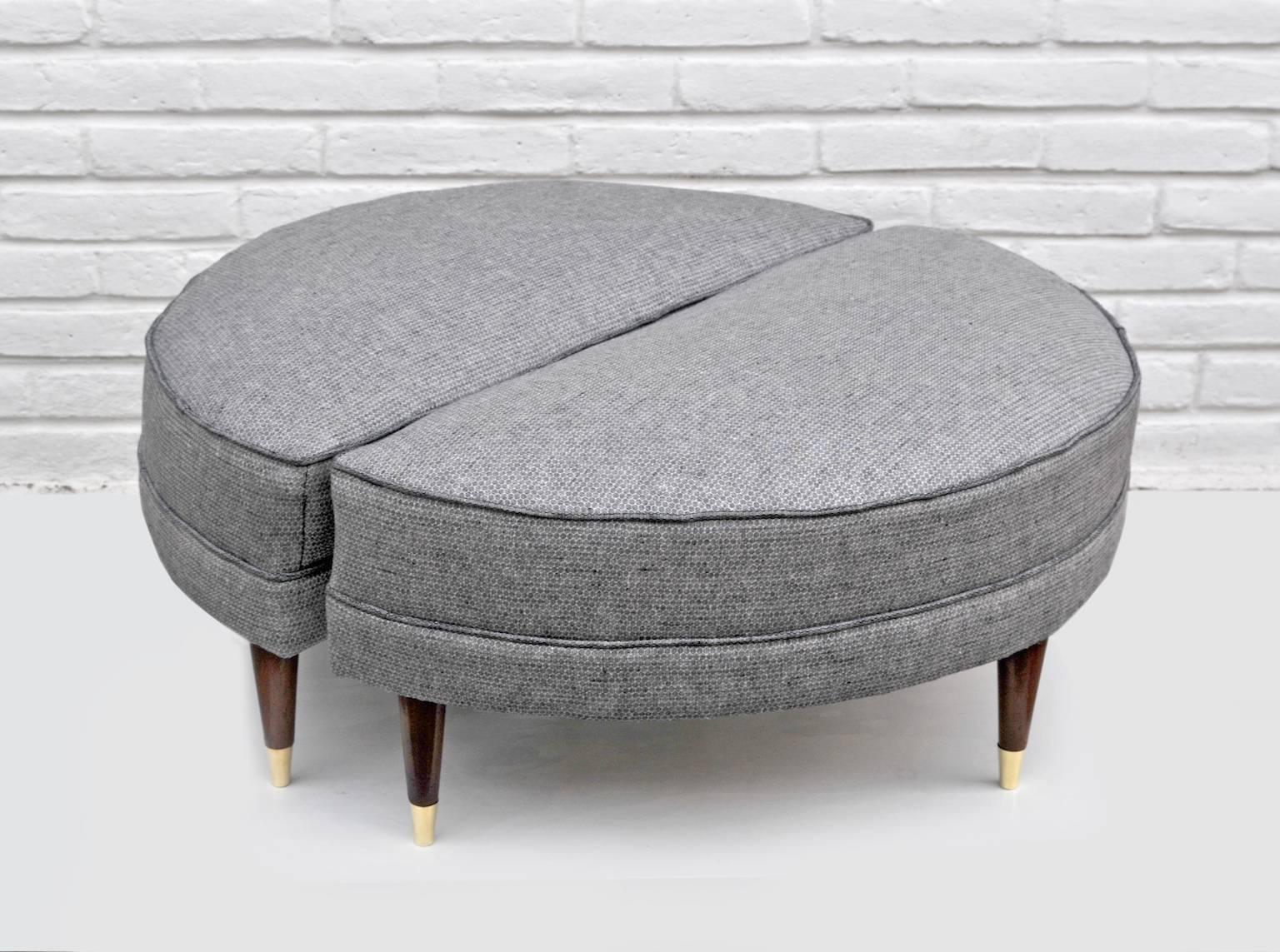 Each of these charming semicircular ottomans has four fruitwood legs with gold toned metal-capped feet. Upholstered in black and creme linen.