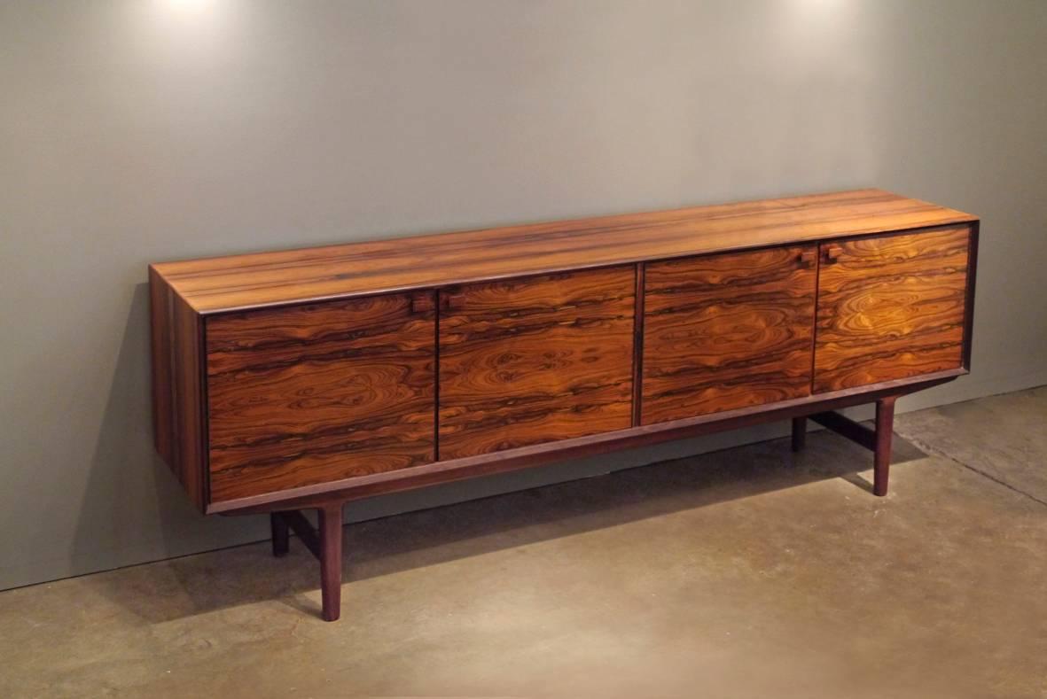 This stunning custom sideboard was designed by Frederick Kayser for the furniture dealer Maurice Villency in New York City. The butterfly grain rosewood has an incredible variation of red tones. Only several of these pieces were produced. This