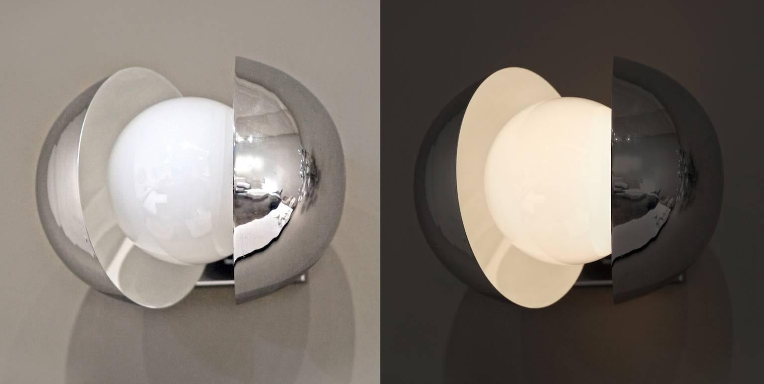 These elegant chrome-plated wall lights give off a beautiful and focused light. Each sphere has two winged parts that are hinged, so they open and close. The interior of each is painted white.