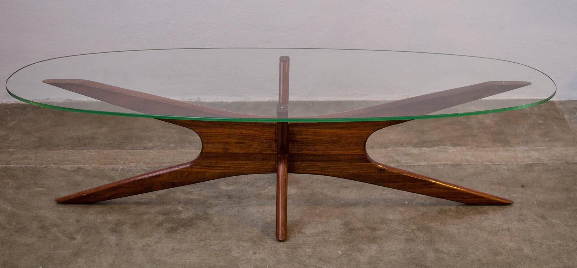A wonderful Adrian Pearsall 'Jacks' coffee table for craft. The table has a walnut base and oval glass top. The piece is in excellent condition.