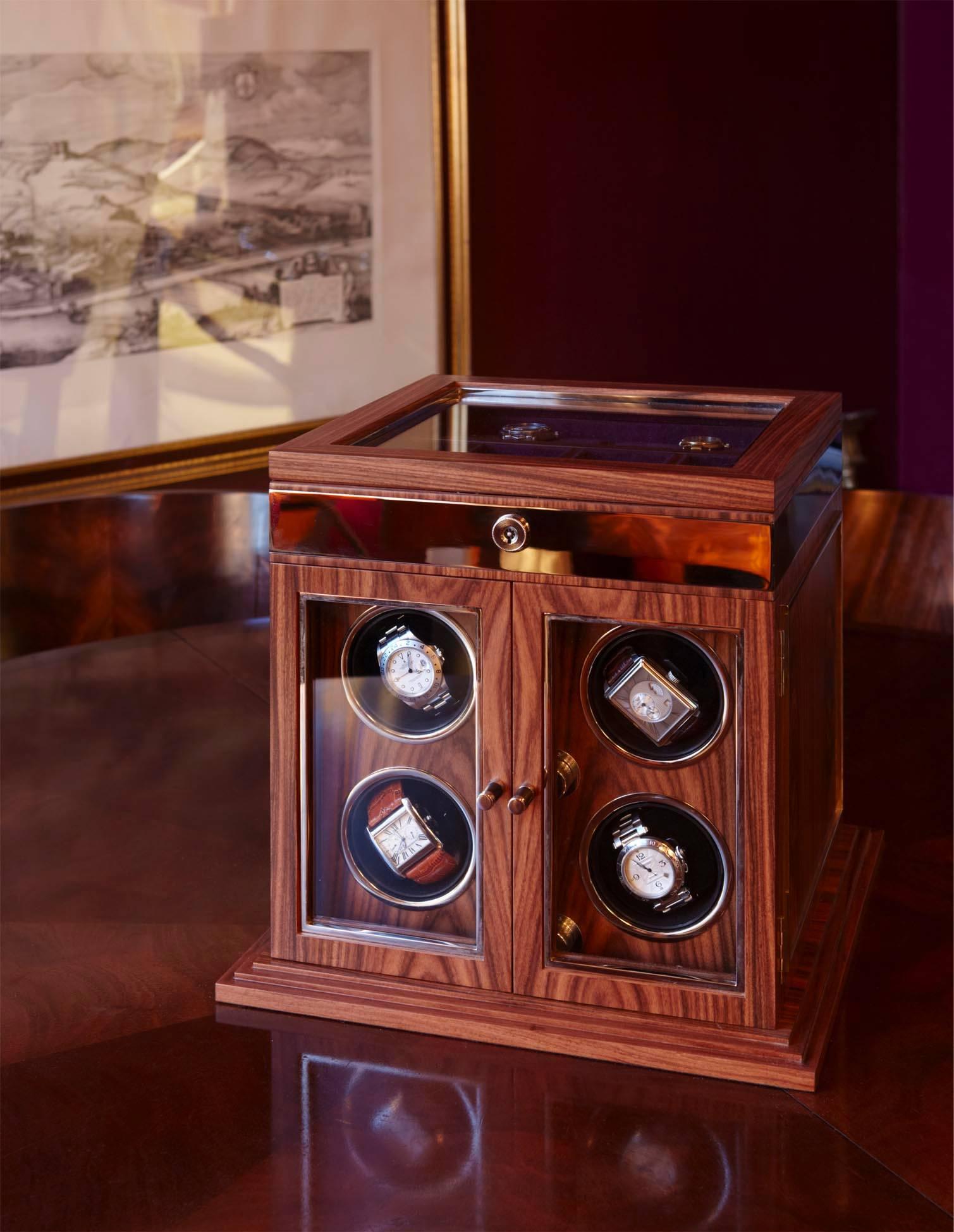 Made of Santos rosewood with inlays and frame working in nickel. The watch box has four multi-directional self-winding rotator cuffs inside. The box has a lift up lid with space for cufflinks and tiepins. The piece locks using the finest lock,