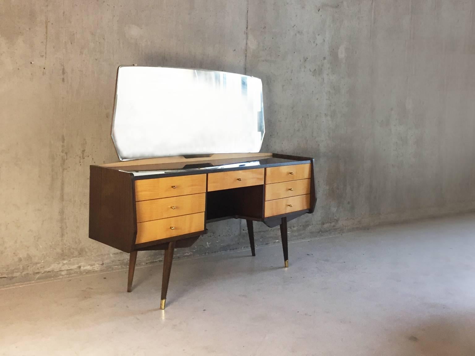A great piece. A 1970s dressing table. The frame is stained beech, and to contrast the drawers are in light beech high gloss veneer. Delicate brass-plated handles and front feet caps. Topped with a large mirror held in place with small detailed